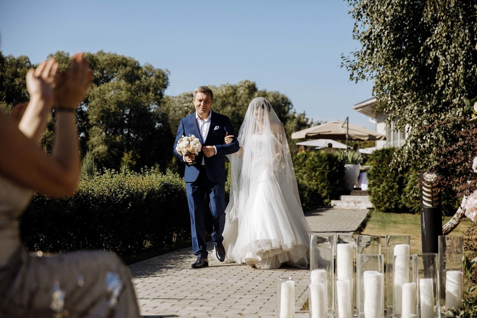 Emotional moment of a father walking his daughter down the aisle, by a Cornwall wedding photographer, Tanya Bogdan.