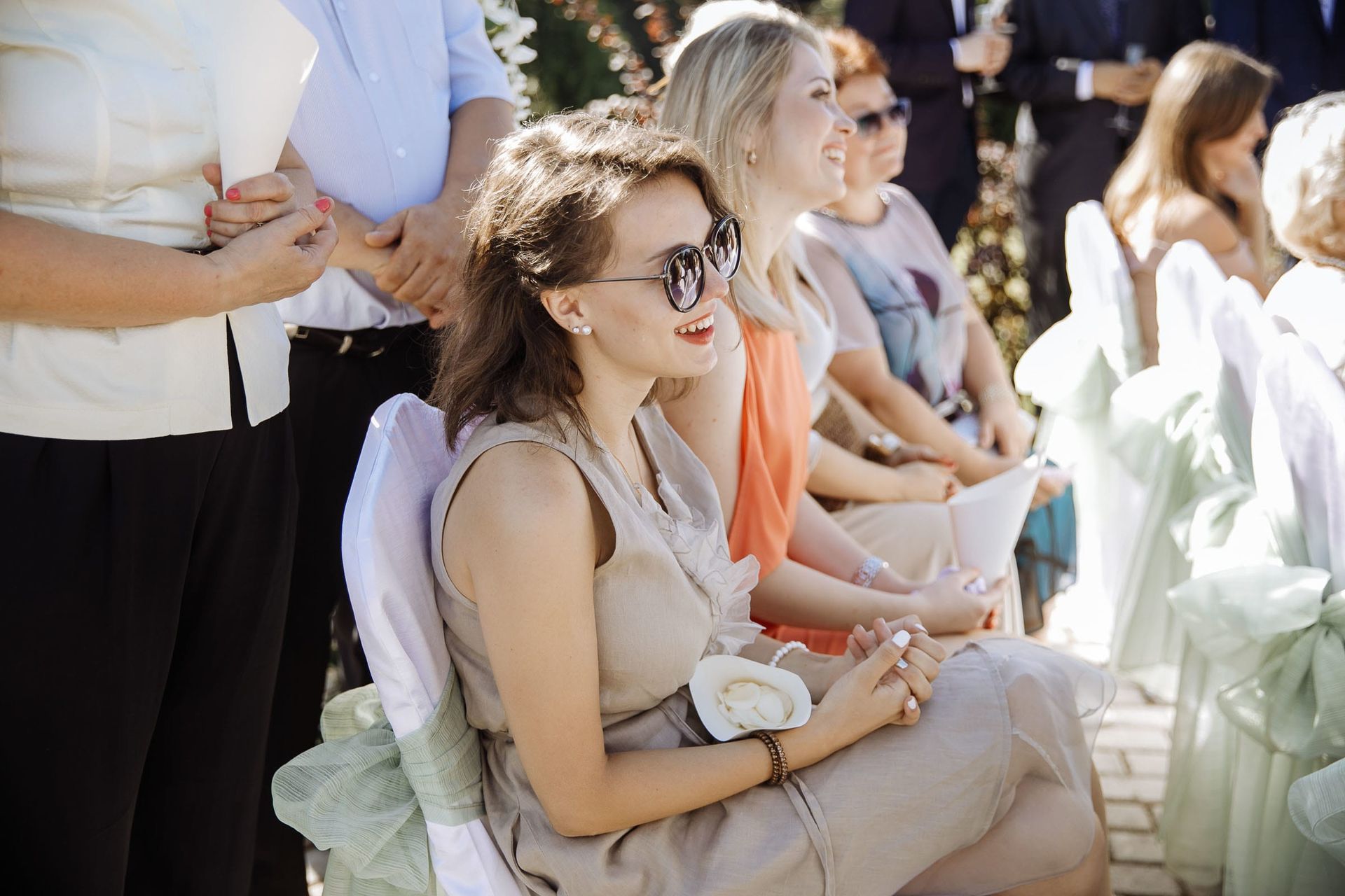 Guests watching an outdoor wedding ceremony, by a wedding photographer, Tanya Bogdan.