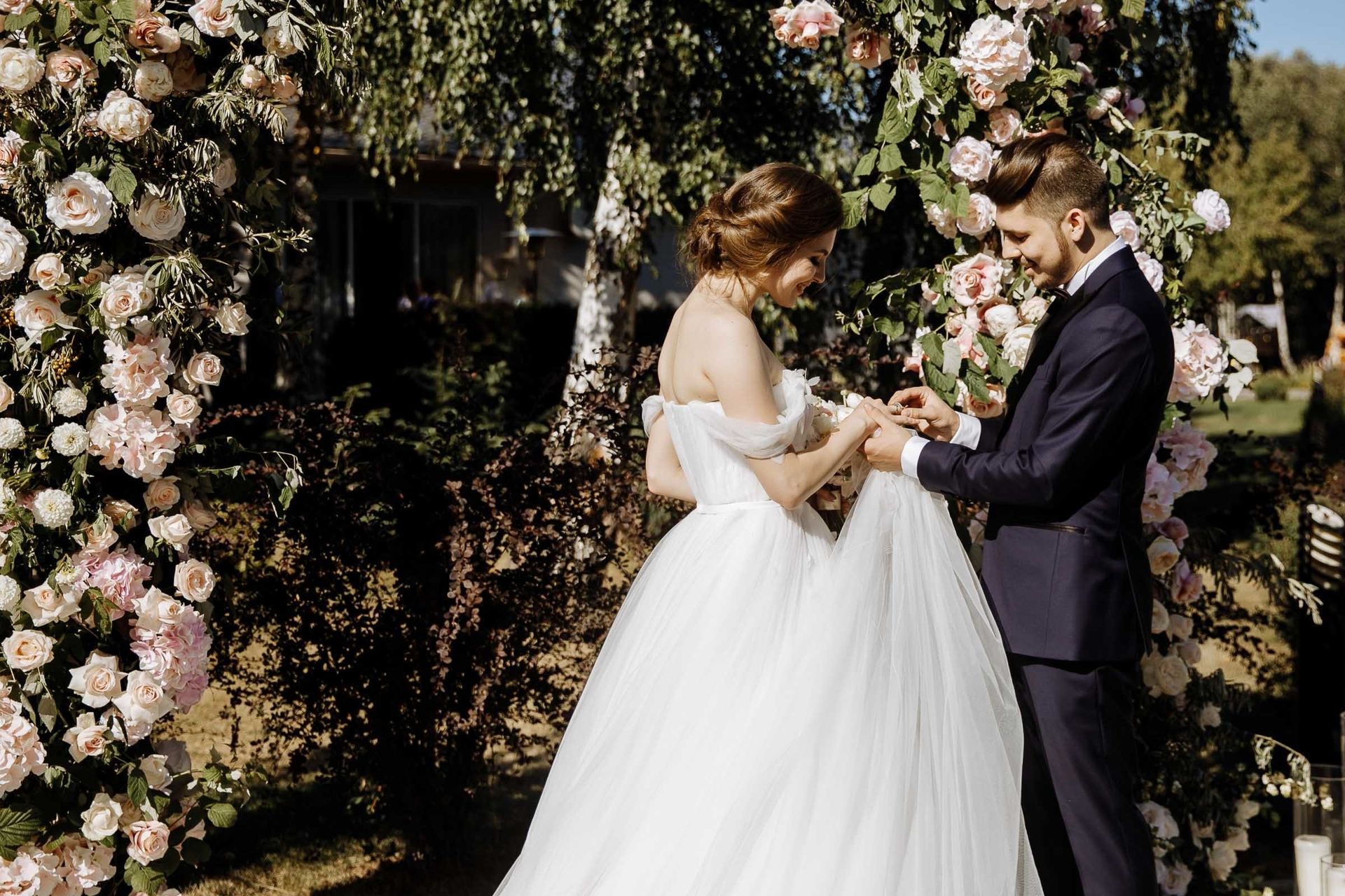 Close-up of the couple exchanging wedding rings at an outdoor ceremony, by a Devon wedding photographer, Tanya Bogdan.