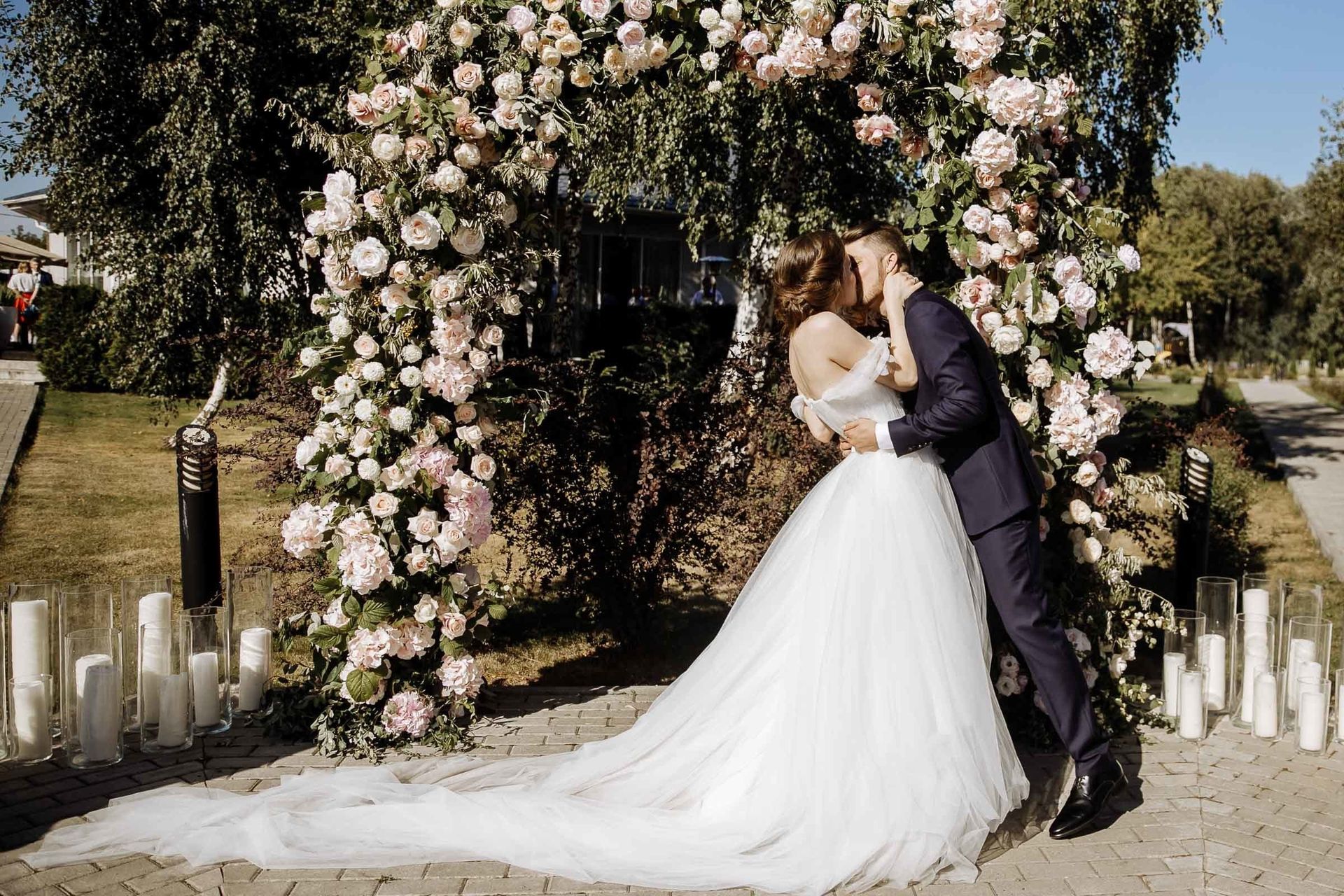 The first kiss as a married couple during an outdoor ceremony.