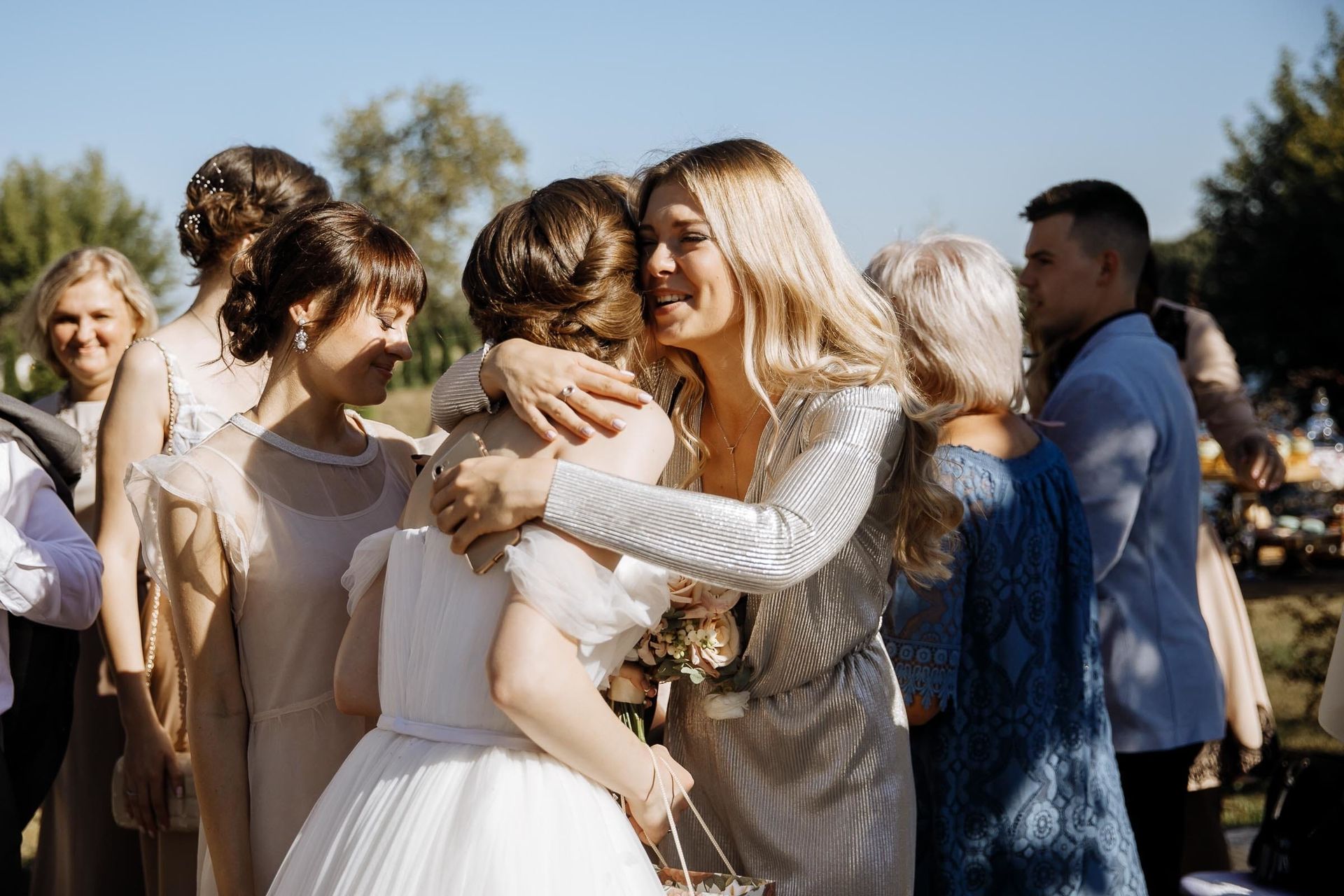 Emotional hugs and congratulations shared after a wedding ceremony, by a Cornwall wedding photographer, Tanya Bogdan.