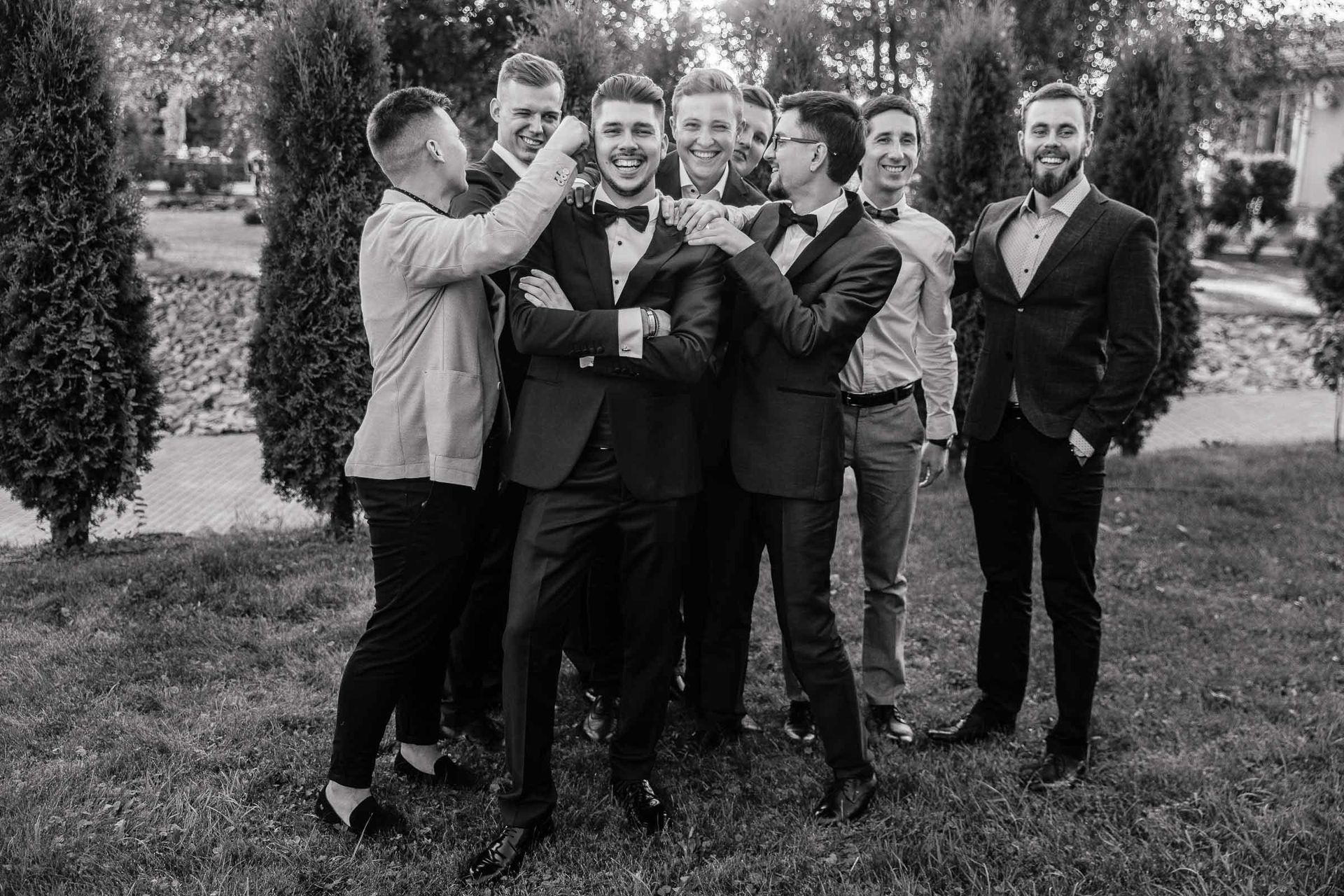 The groom being congratulated by his groomsmen.