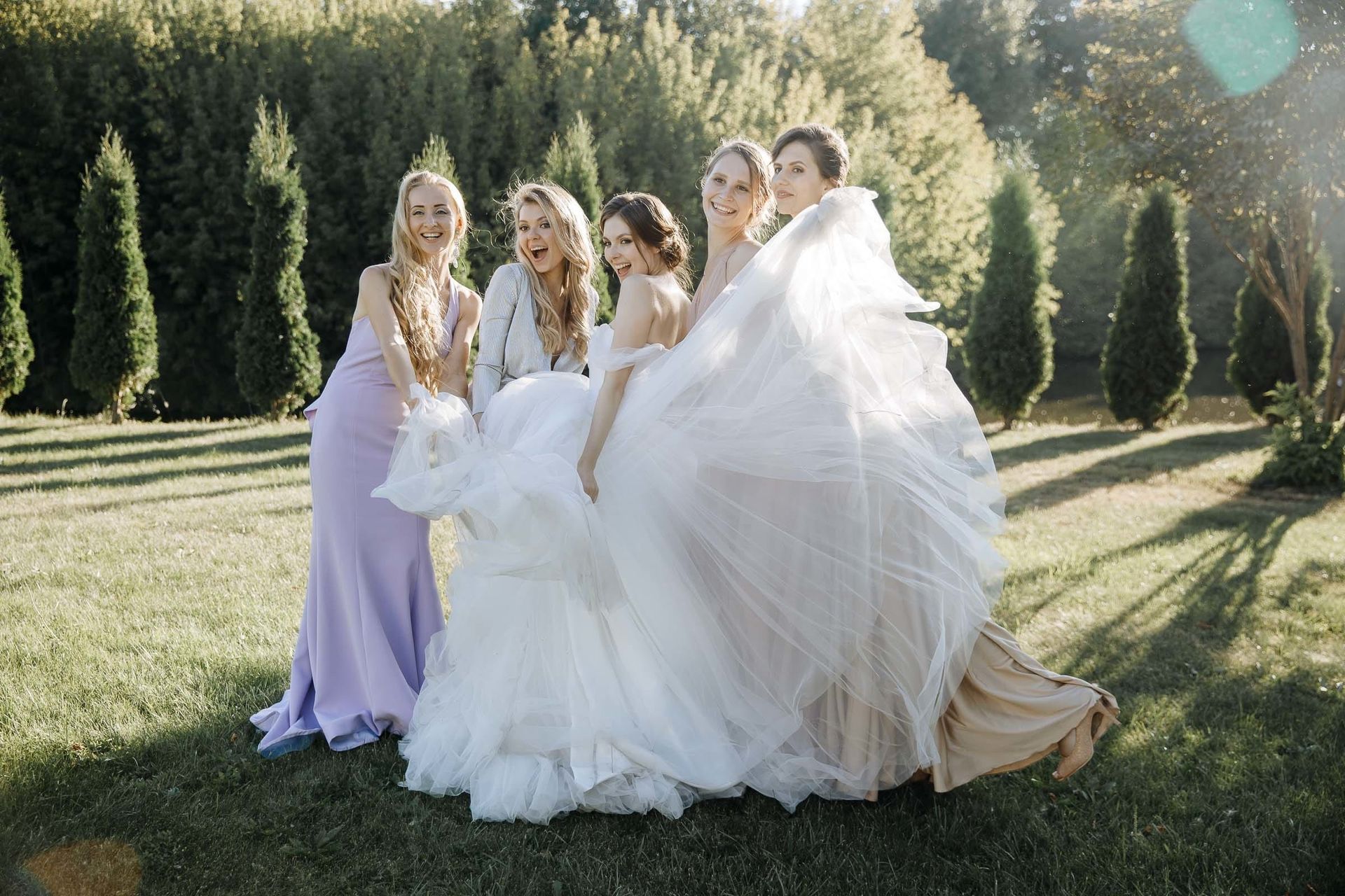 A relaxed portrait of the bride and her bridesmaids, by a Devon wedding photographer, Tanya Bogdan.