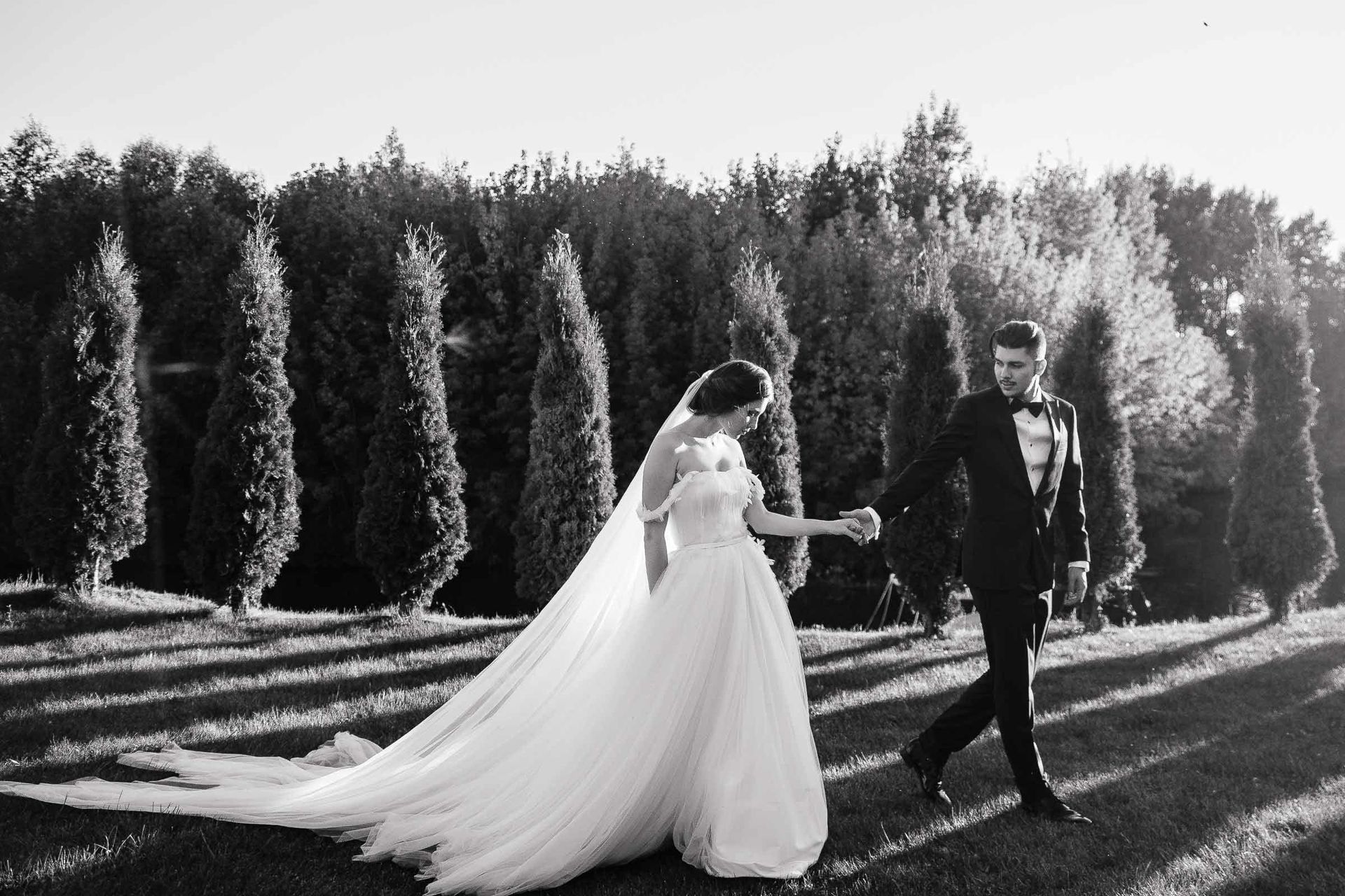 A cinematic shot of the bride and groom walking together in the South West, by a South West wedding photographer, Tanya Bogdan.