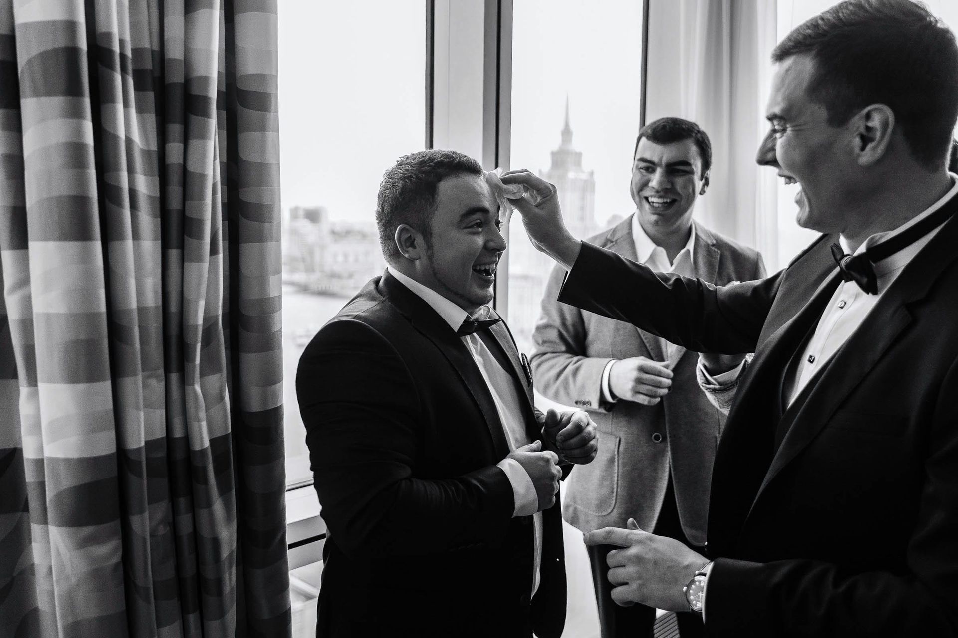 Fun black and white wedding portraits of groom and groomsmen documentary style by London wedding Photographer Tanya Bogdan.