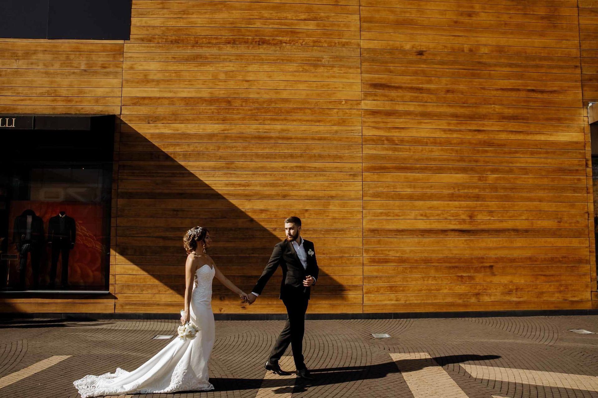 Dramatic wide documentary shot of a bride and groom in a city landscape by London wedding photographer Tanya Bogdan.