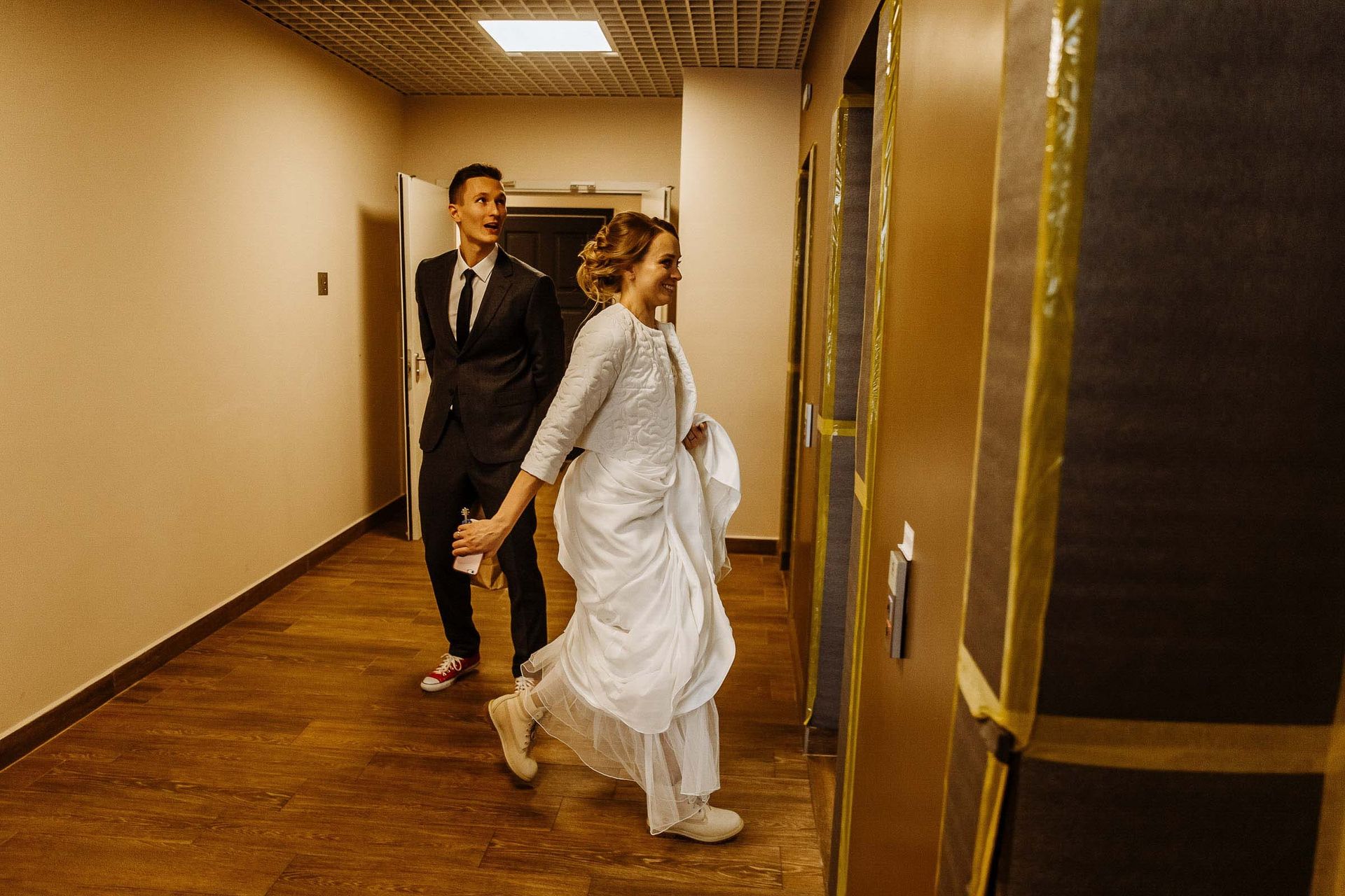 Urban documentary wedding photography of bride and groom entering lift from London wedding photographer Tanya Bogdan.