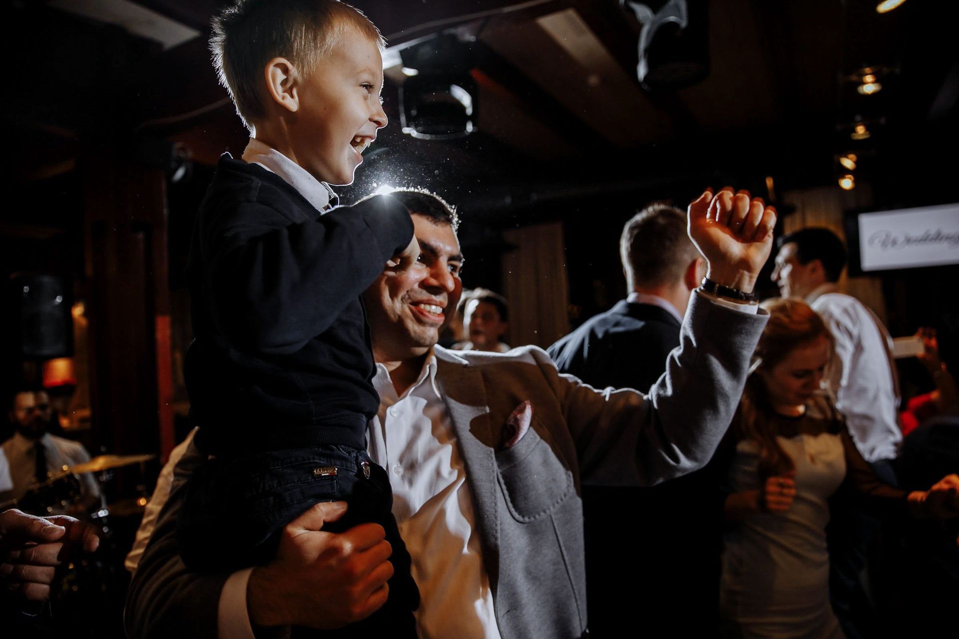Father and child on the wedding dancefloor. By Tanya Bogdan.