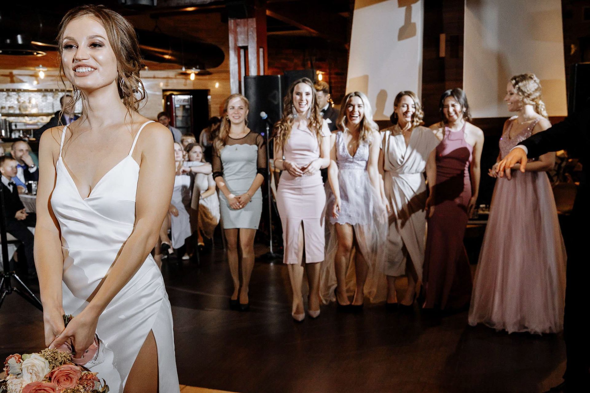 The bouquet toss moment; Cornwall wedding photography specialist.