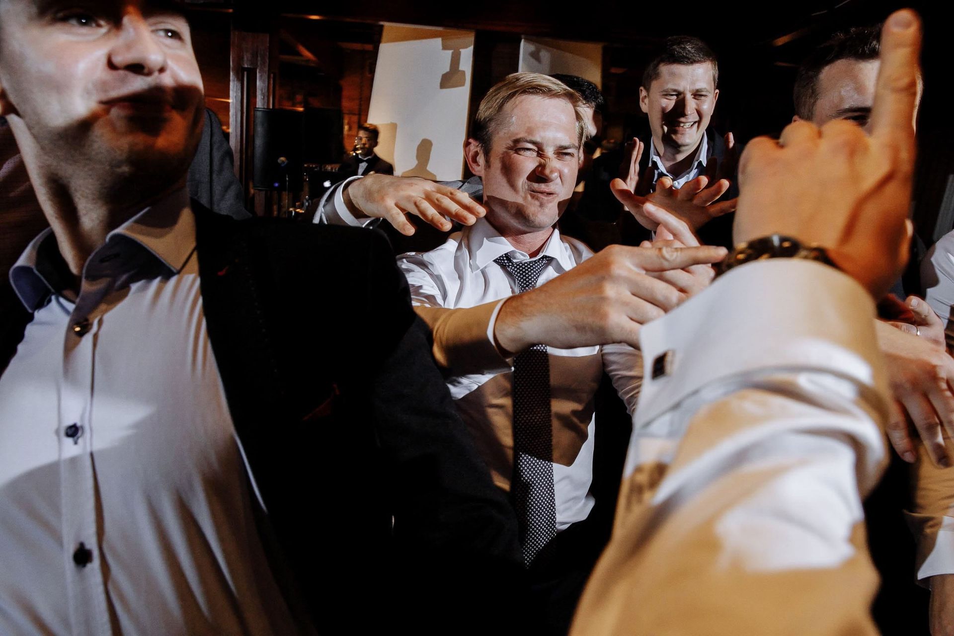 Candid reception photography of guests celebrating by Cornwall wedding photographer Tanya Bogdan.