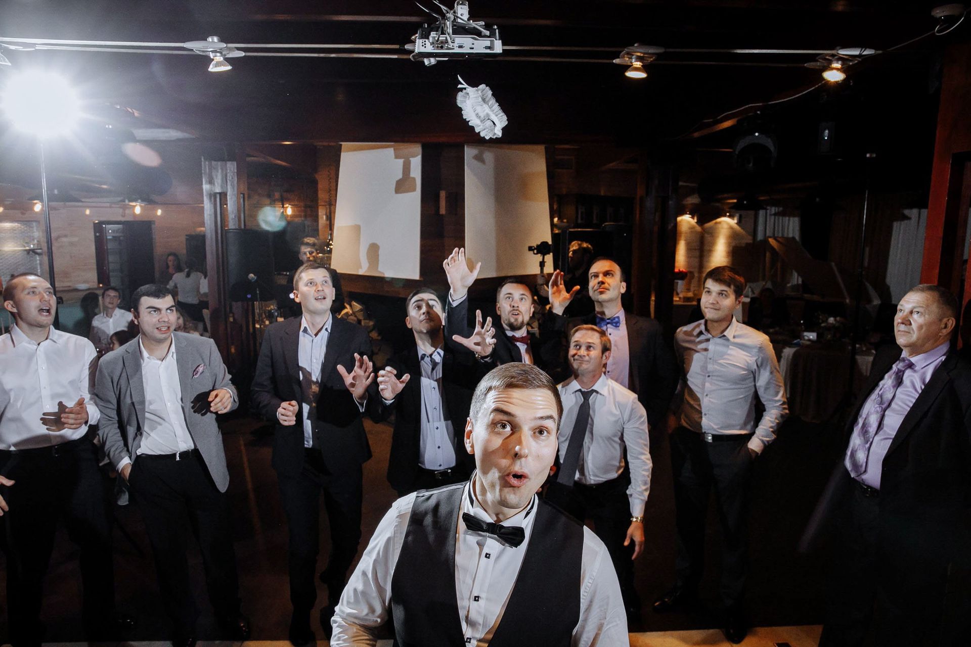 The garter toss. Authentic reception moments; wedding photography by Tanya Bogdan.