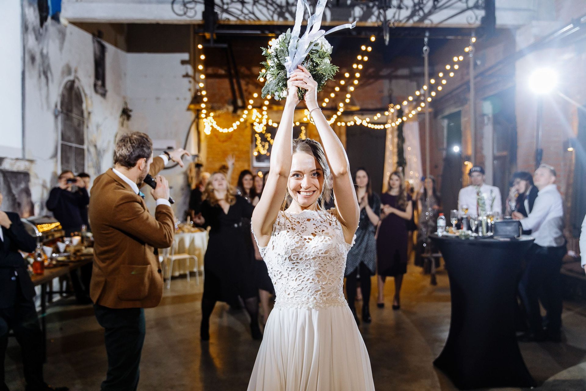 Action photography of the bridal bouquet toss from Devon wedding photographer Tanya Bogdan.