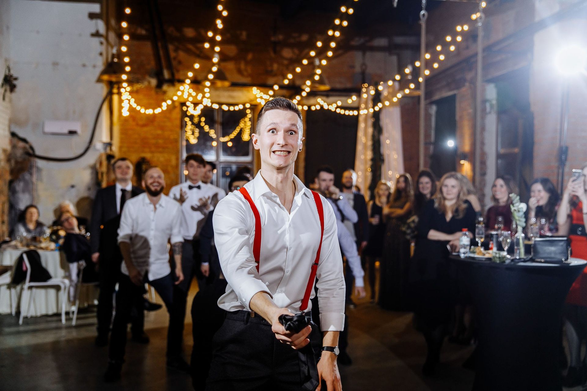 Editorial reportage photography of the garter toss by Tanya Bogdan.
