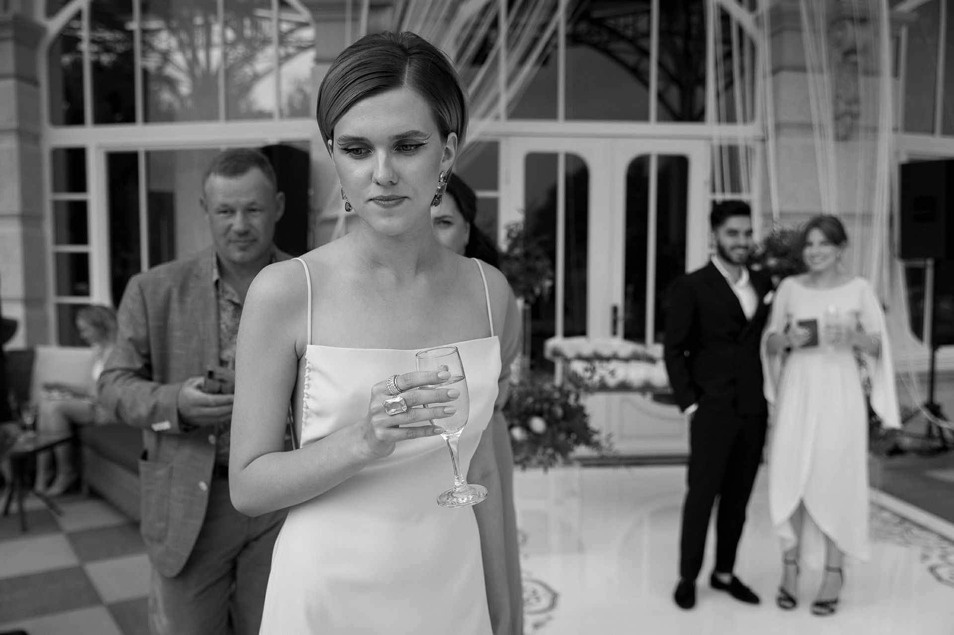 Black and white documentary photo of guests during a destination wedding reception