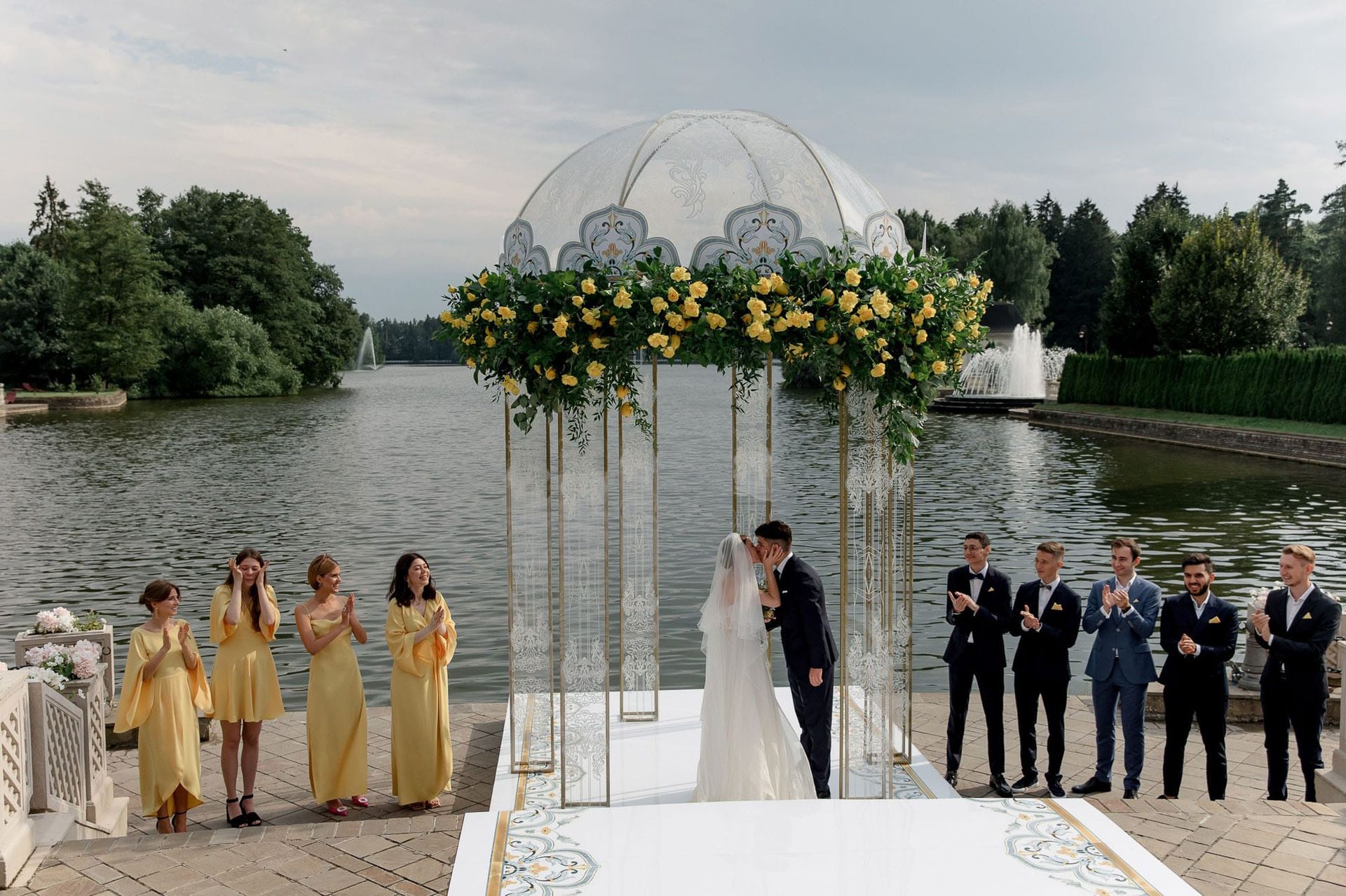 Wide ceremony view beside a river during a destination wedding