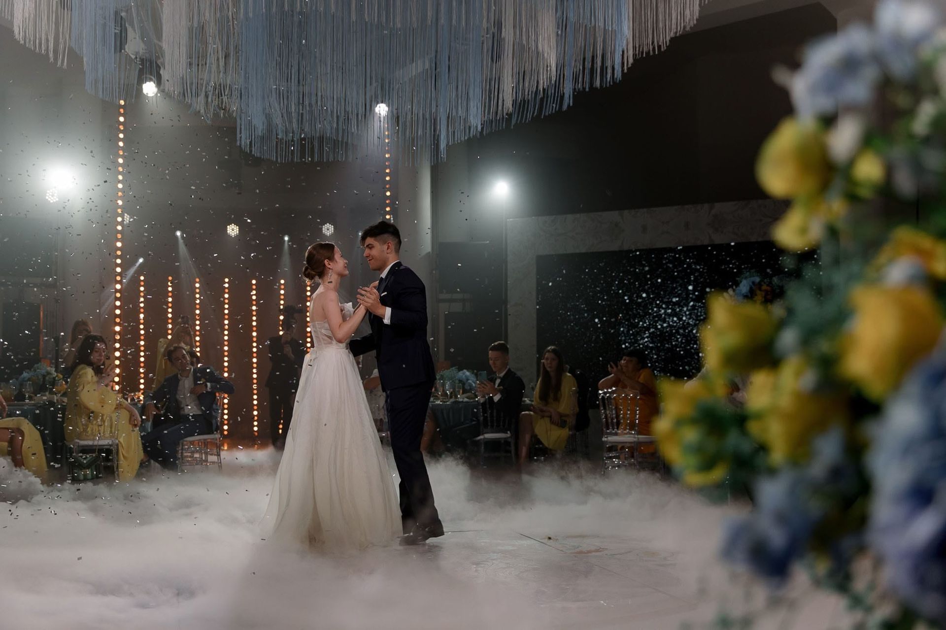 Wide editorial view of the bride and groom during their first dance