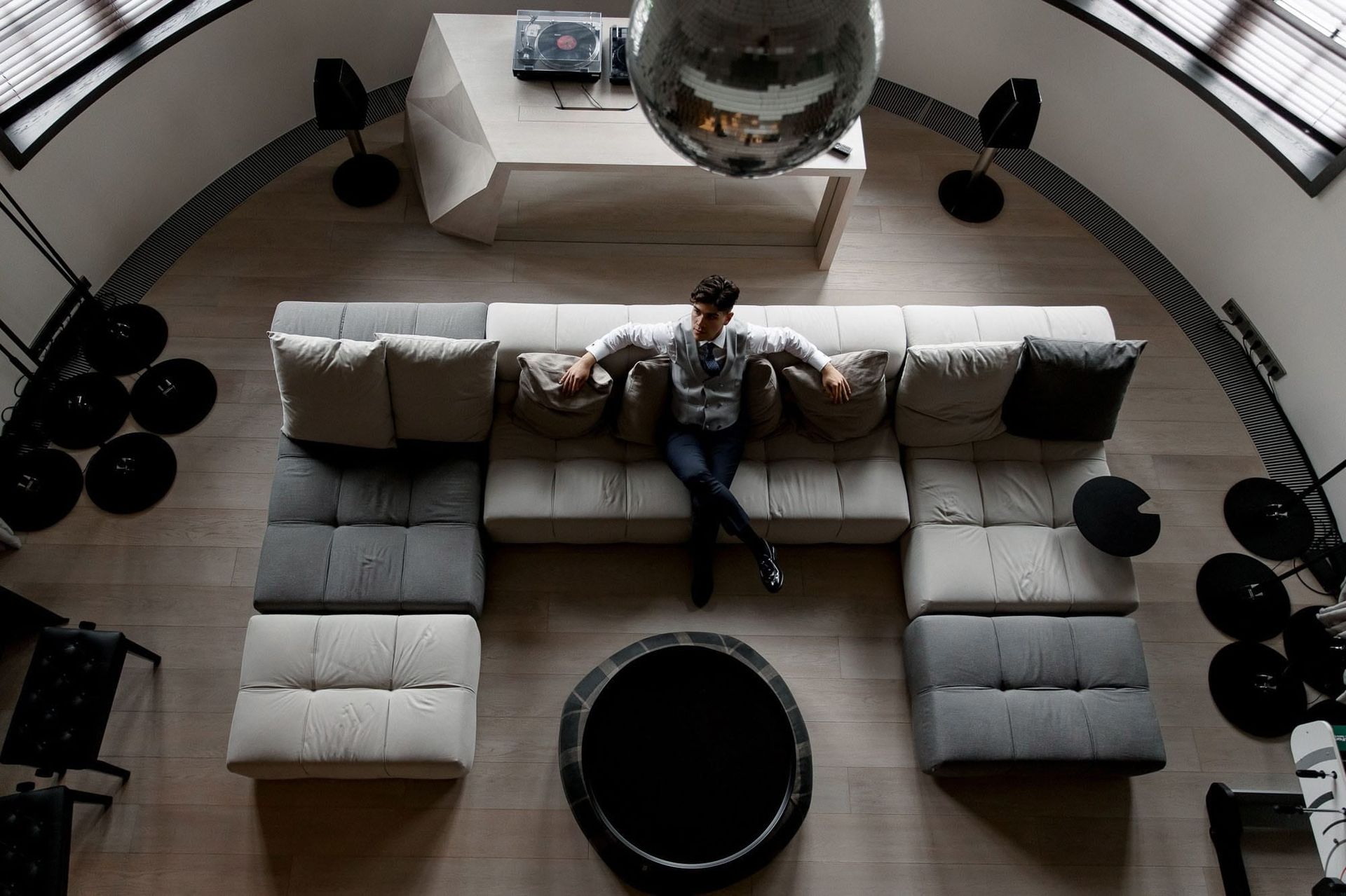Overhead portrait of the groom relaxing on a sofa during destination wedding preparations