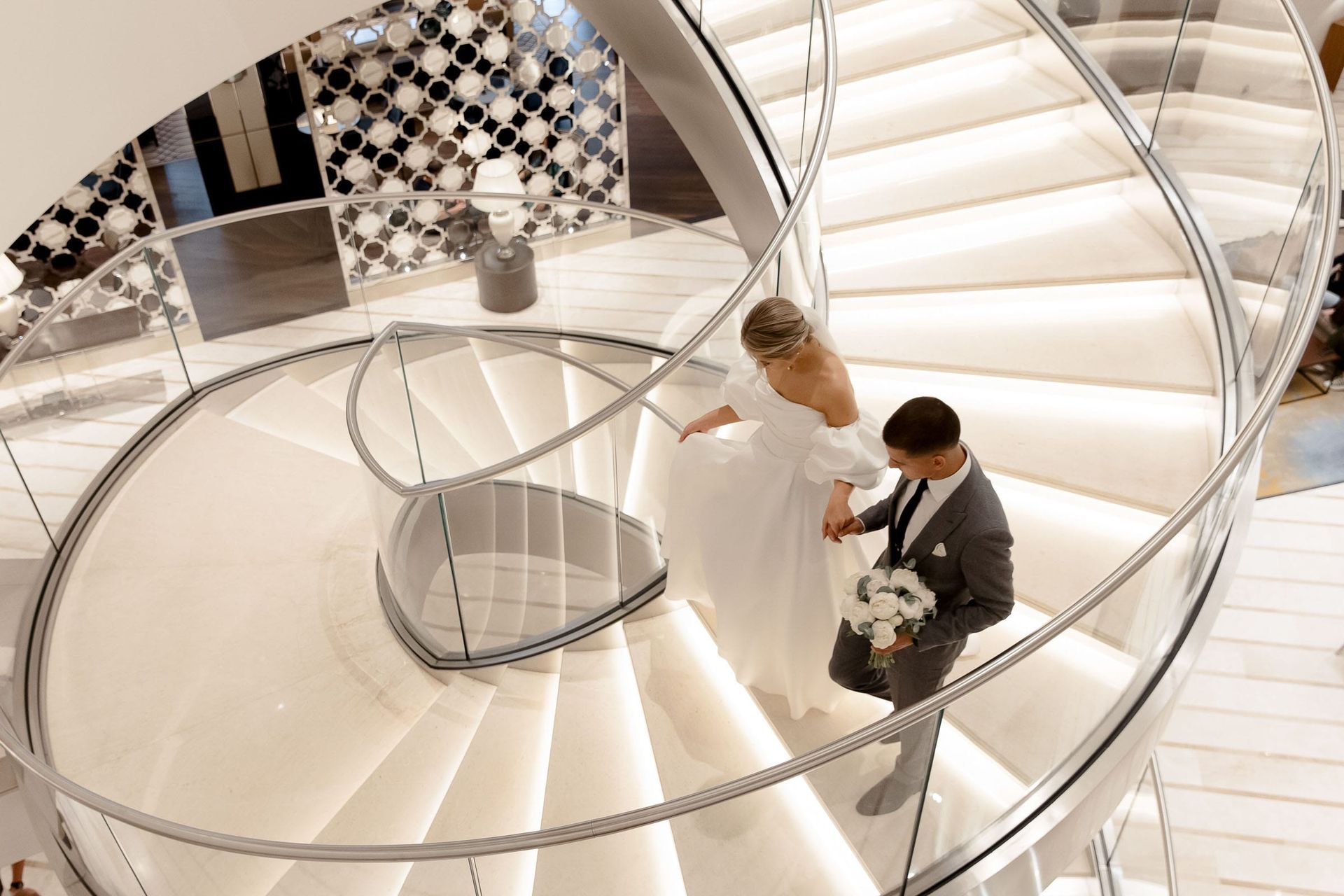 Wide editorial shot of a wedding couple on a spiral staircase from Bude wedding photographer Tanya Bogdan.
