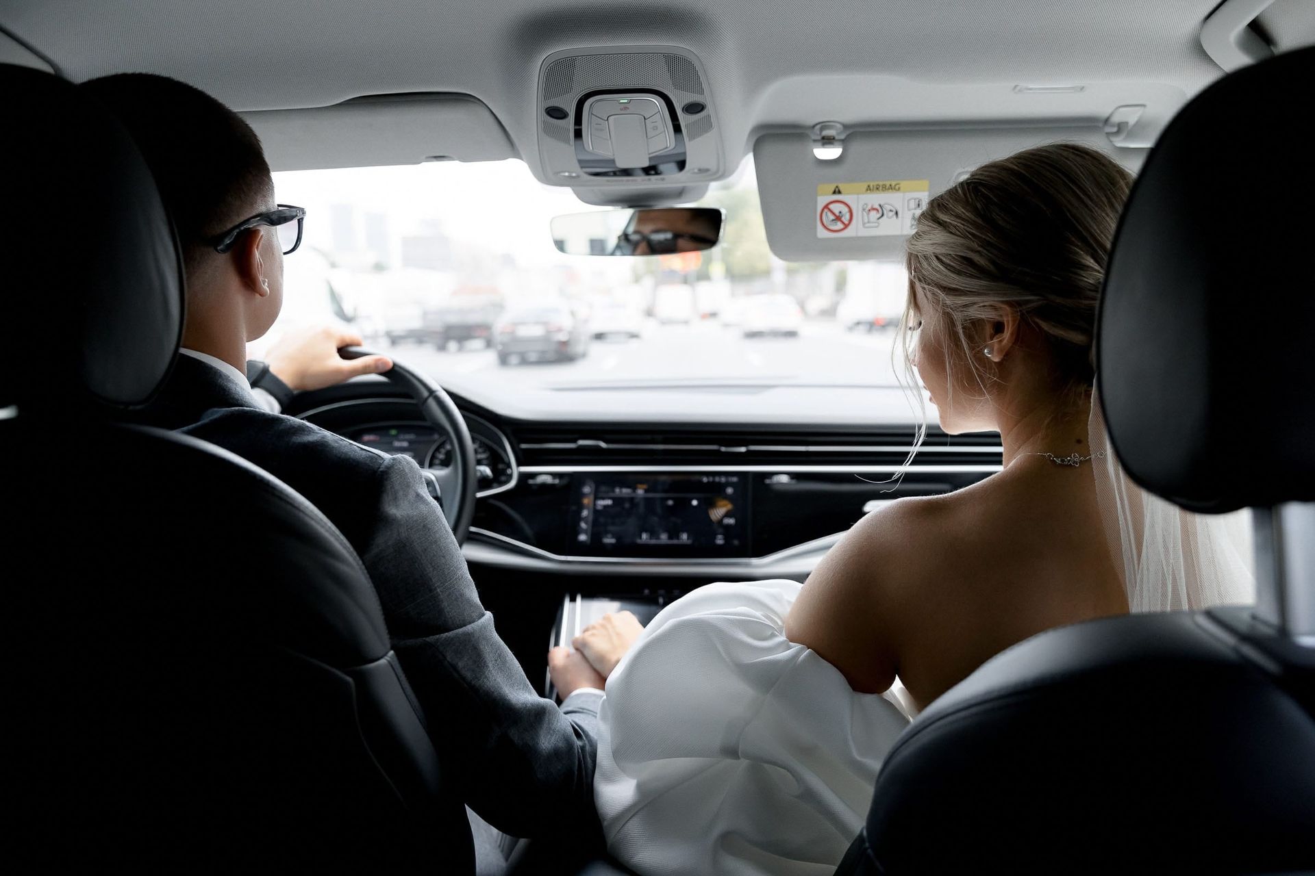 Candid moment of the groom driving the bride from Cornwall wedding photographer Tanya Bogdan.