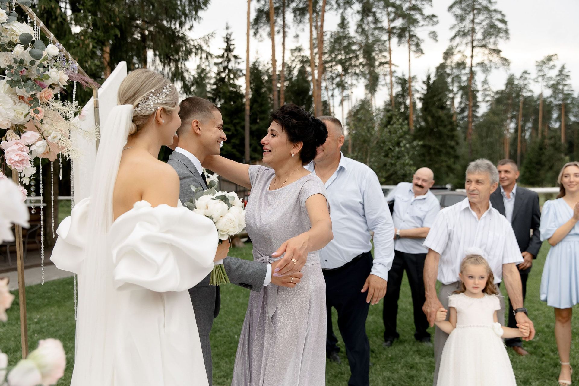 Candid outdoor guest congratulations from Devon wedding photographer Tanya Bogdan.