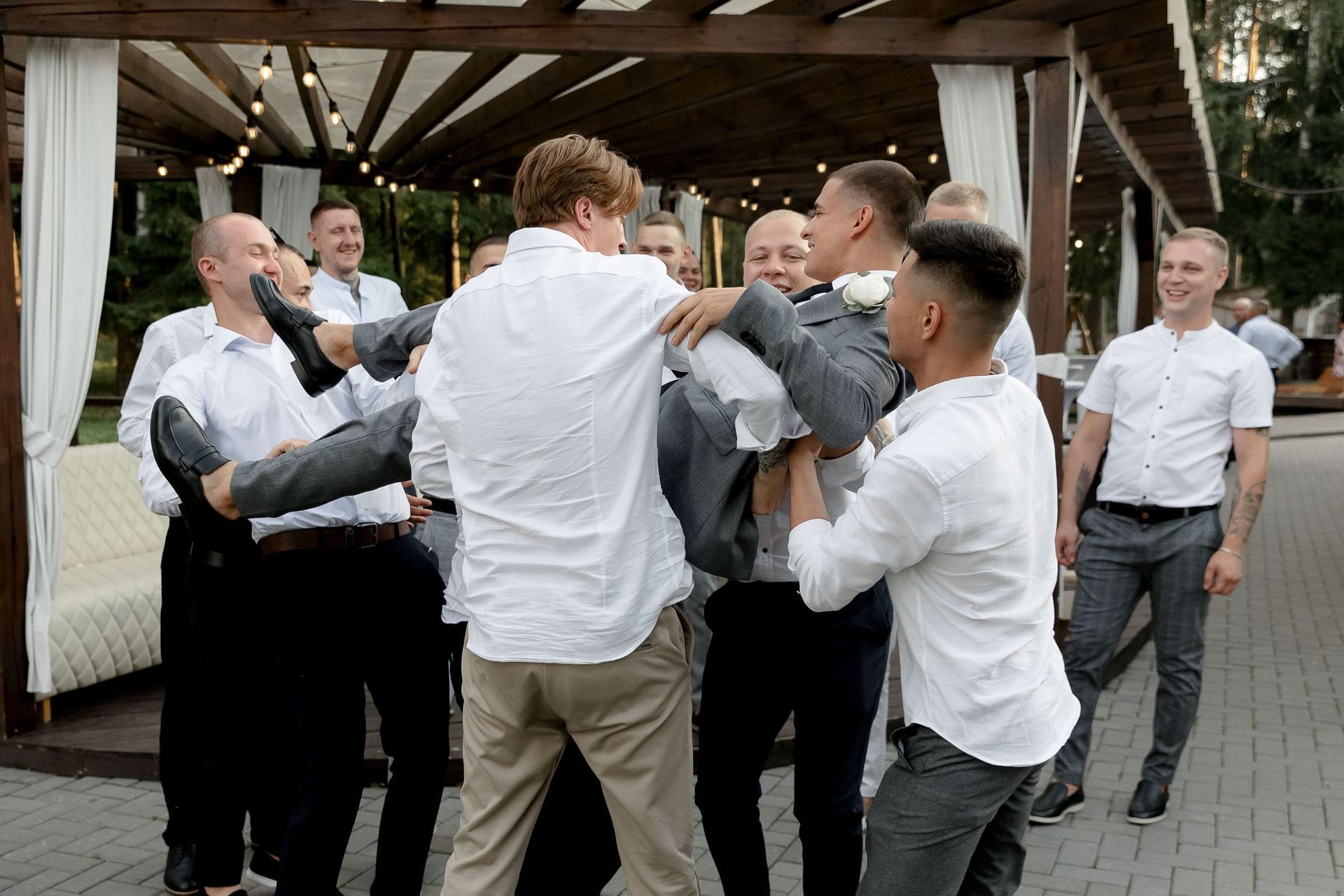 Vibrant documentary wedding reception photography of the groom with groomsmen from Bude wedding photographer Tanya Bogdan.
