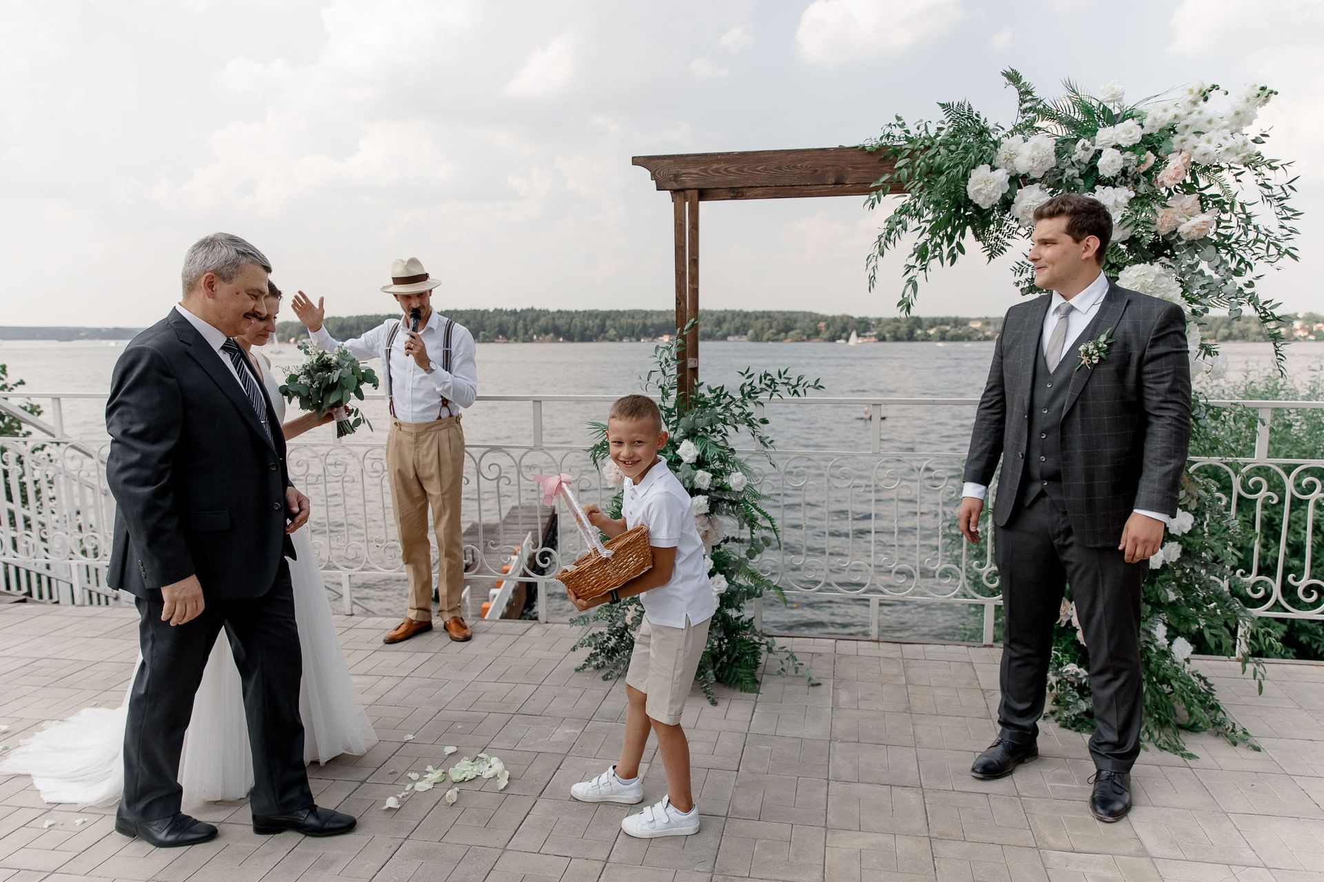A candid shot of a page boy during a riverside wedding ceremony, photographed by Tanya Bogdan.