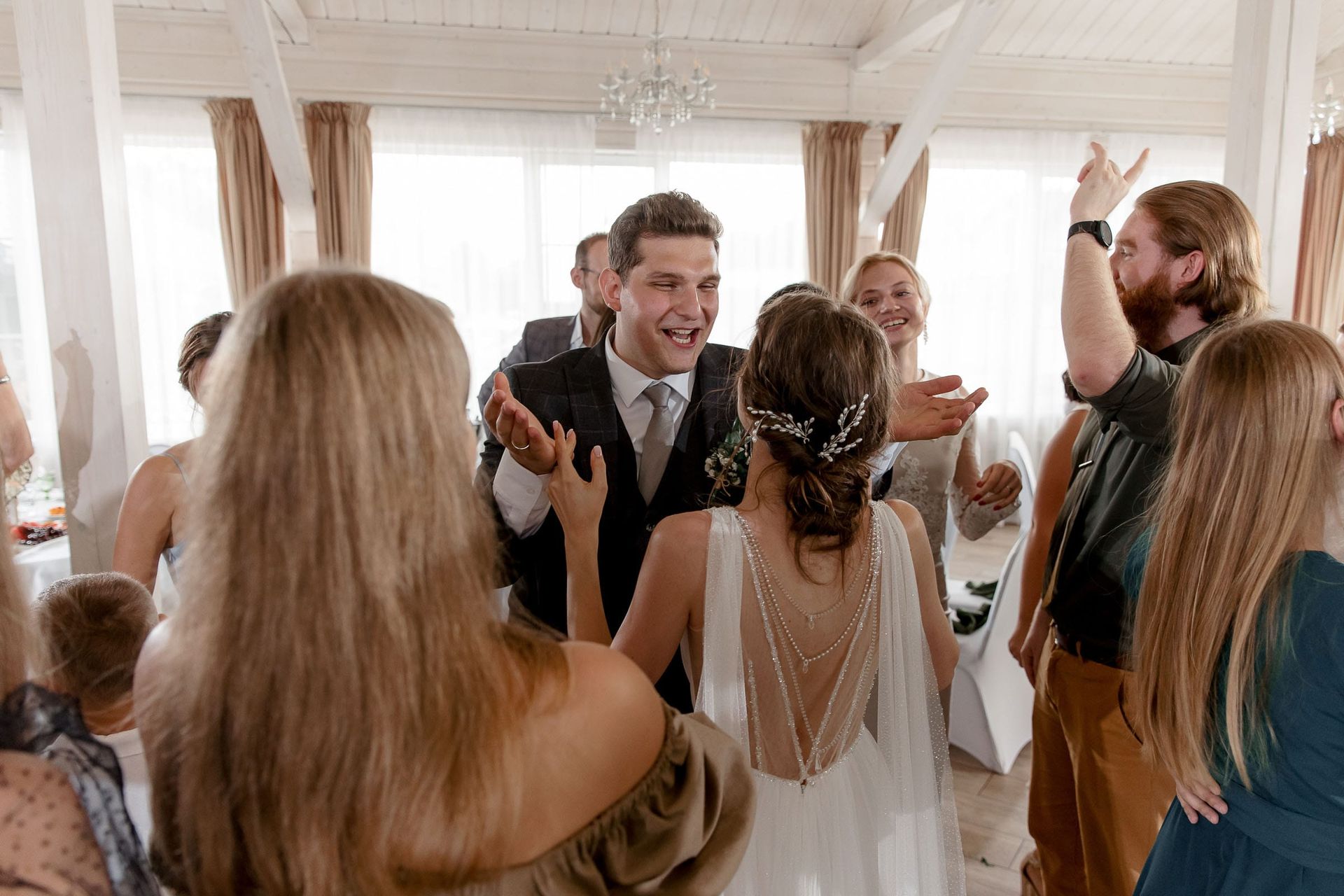 Candid laughter during a wedding reception, captured by Bude wedding photographer Tanya Bogdan.