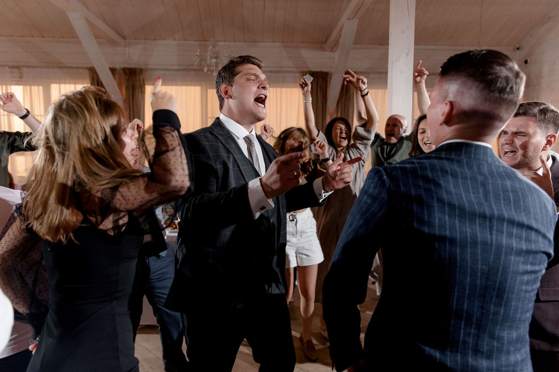 Candid laughter during a wedding reception, captured by Bude wedding photographer Tanya Bogdan.