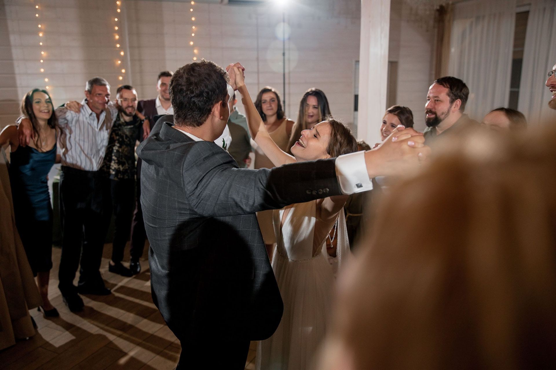 An action shot of wedding guests on the dancefloor by a South West wedding photographer.