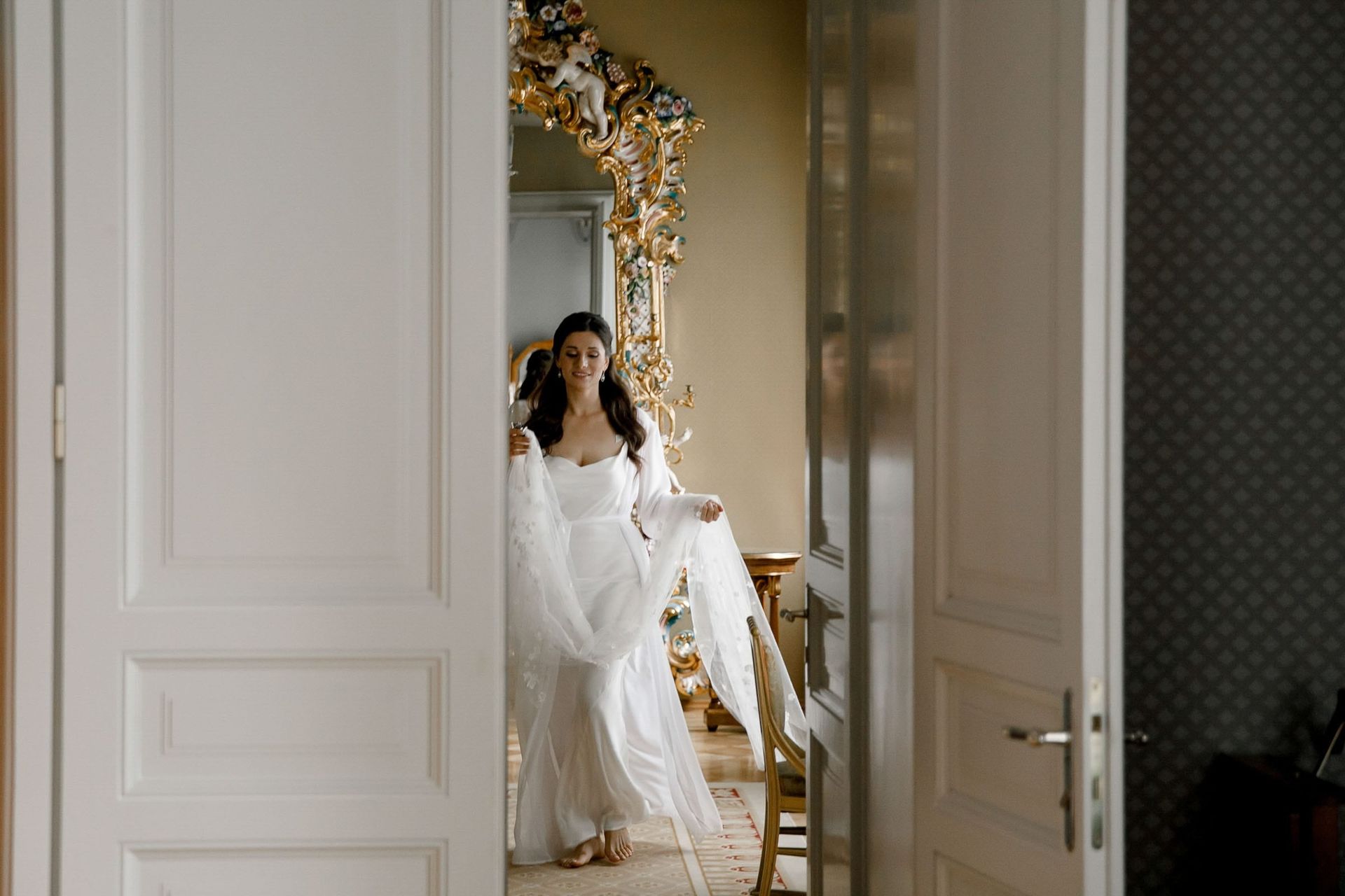 A candid documentary shot of a bride in a doorway, captured by London editorial wedding photographer Tanya Bogdan.