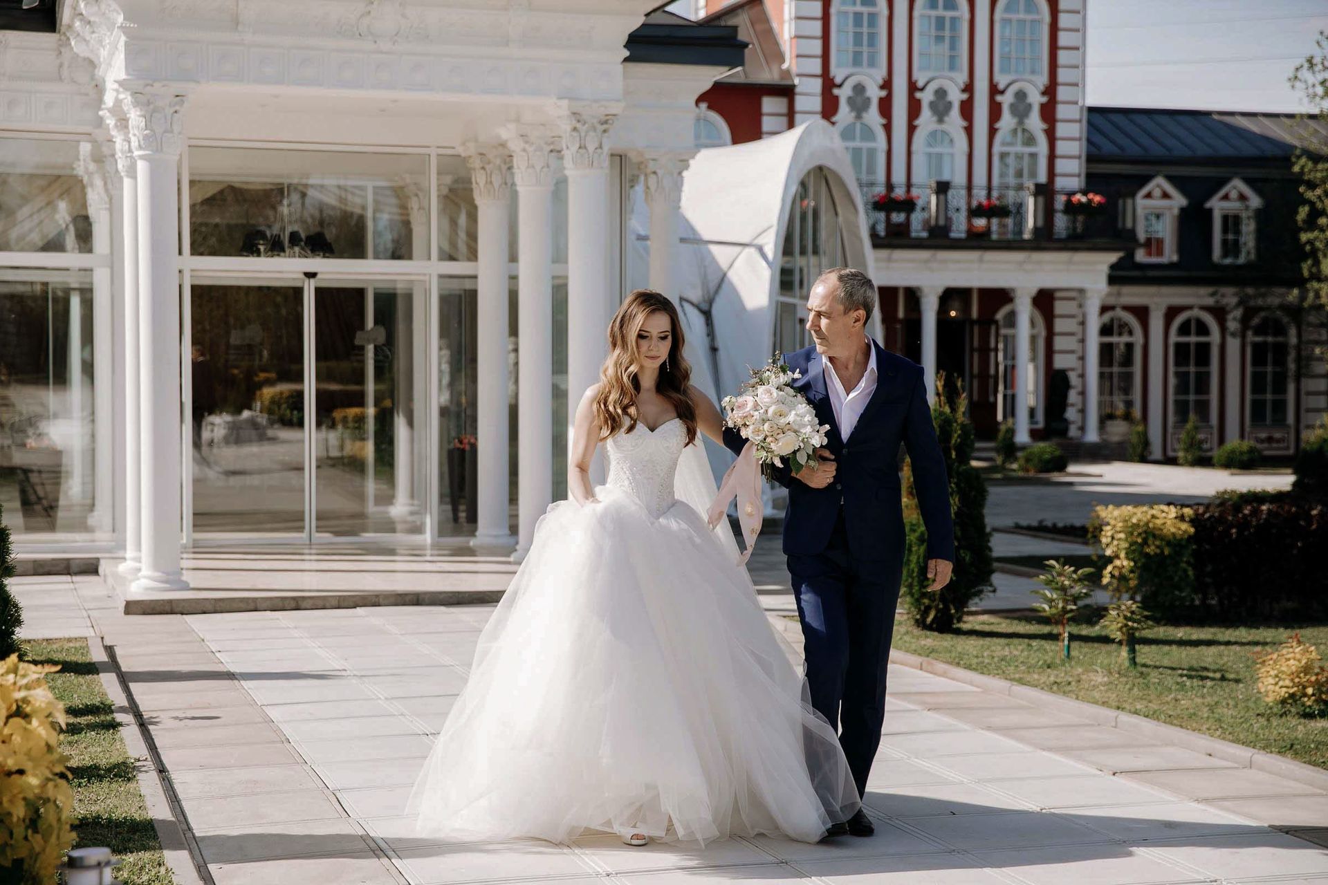 An emotional documentary moment of the bride and her father walking the aisle by Tanya Bogdan.