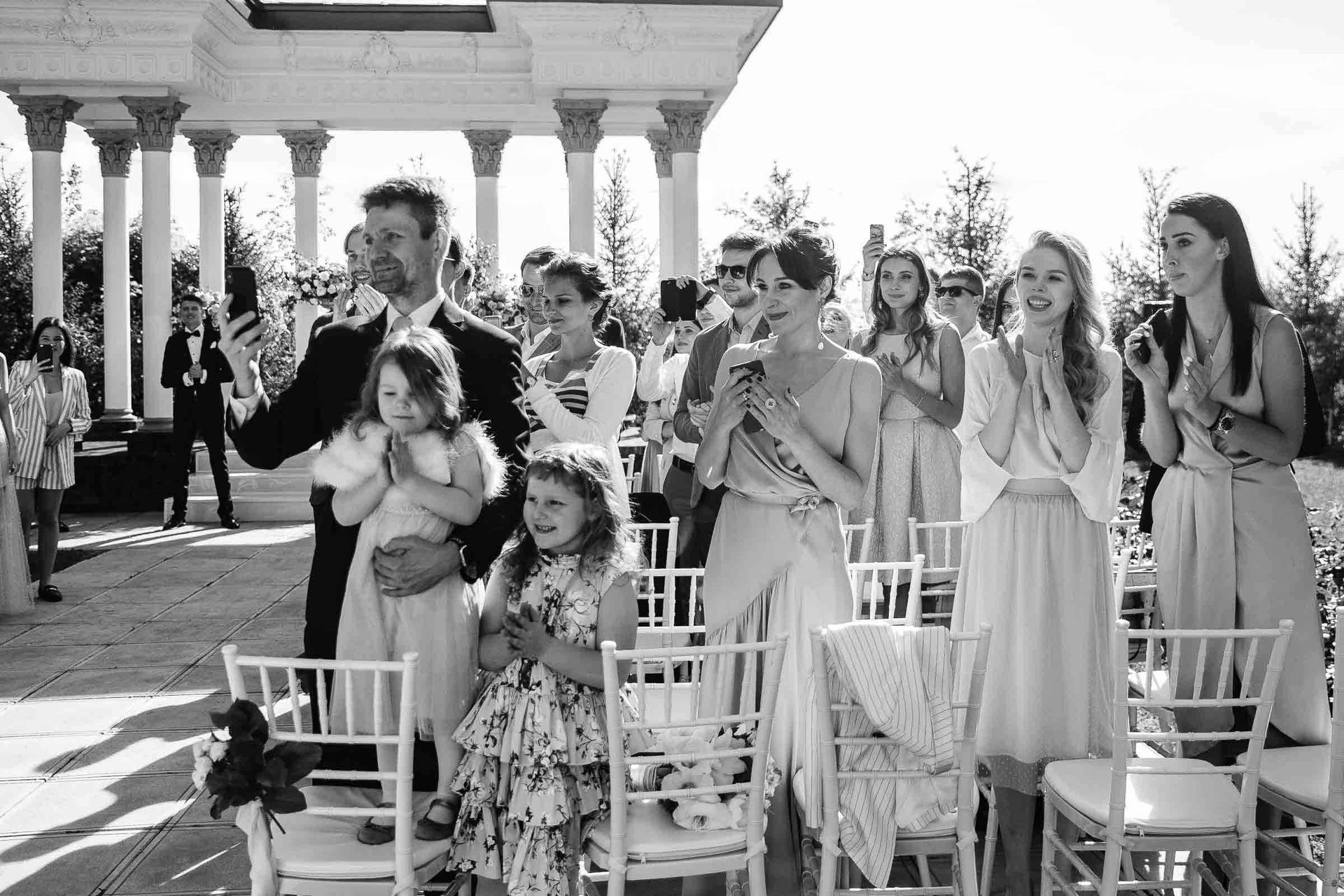 An emotional black and white documentary shot of wedding guests by Tanya Bogdan.