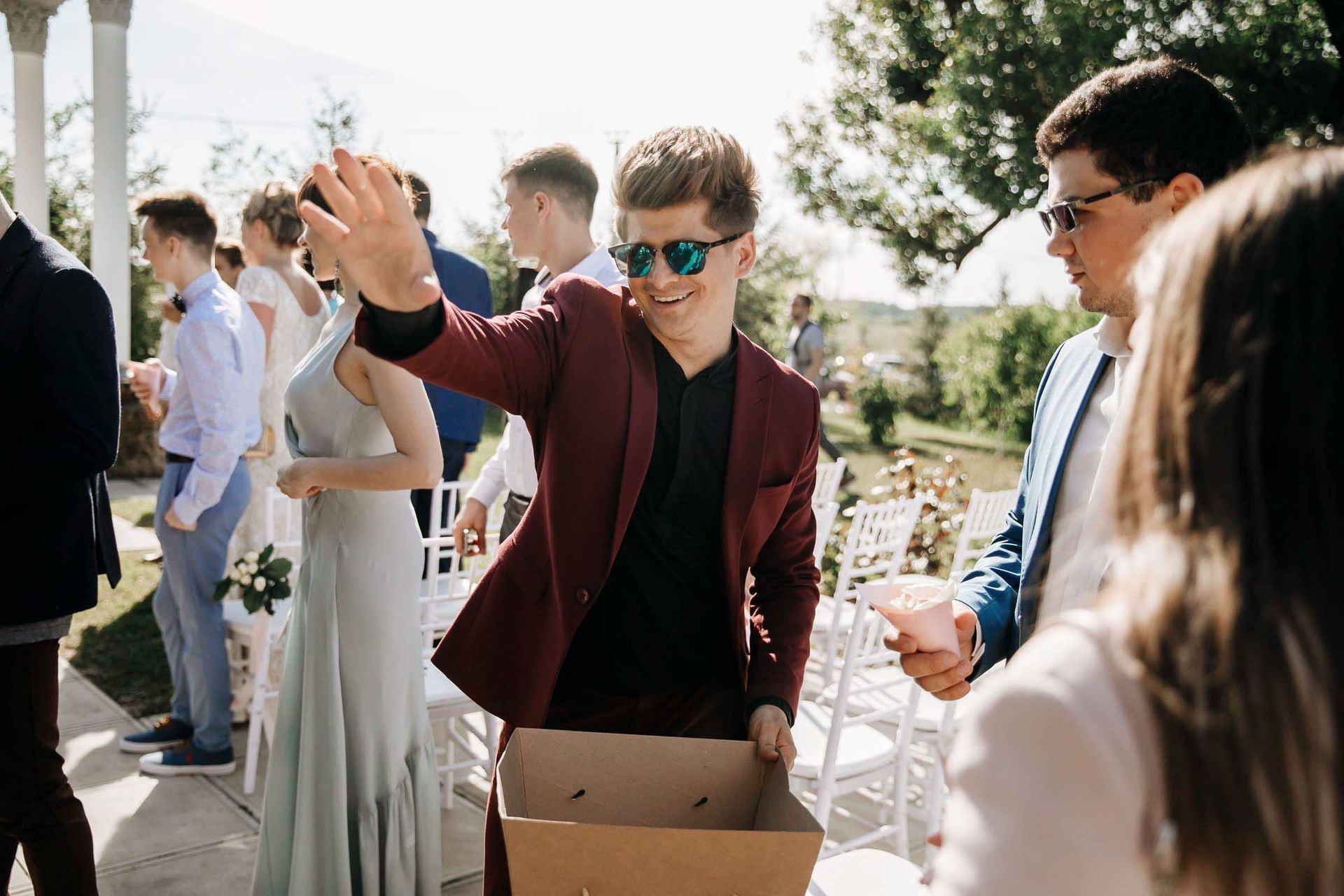 A joyful documentary moment of a wedding guest, captured by Tanya Bogdan.