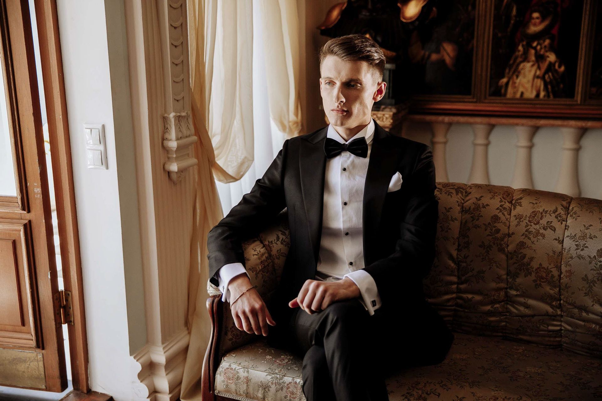 A sophisticated editorial groom portrait in a classic black tuxedo by London wedding photographer Tanya Bogdan.
