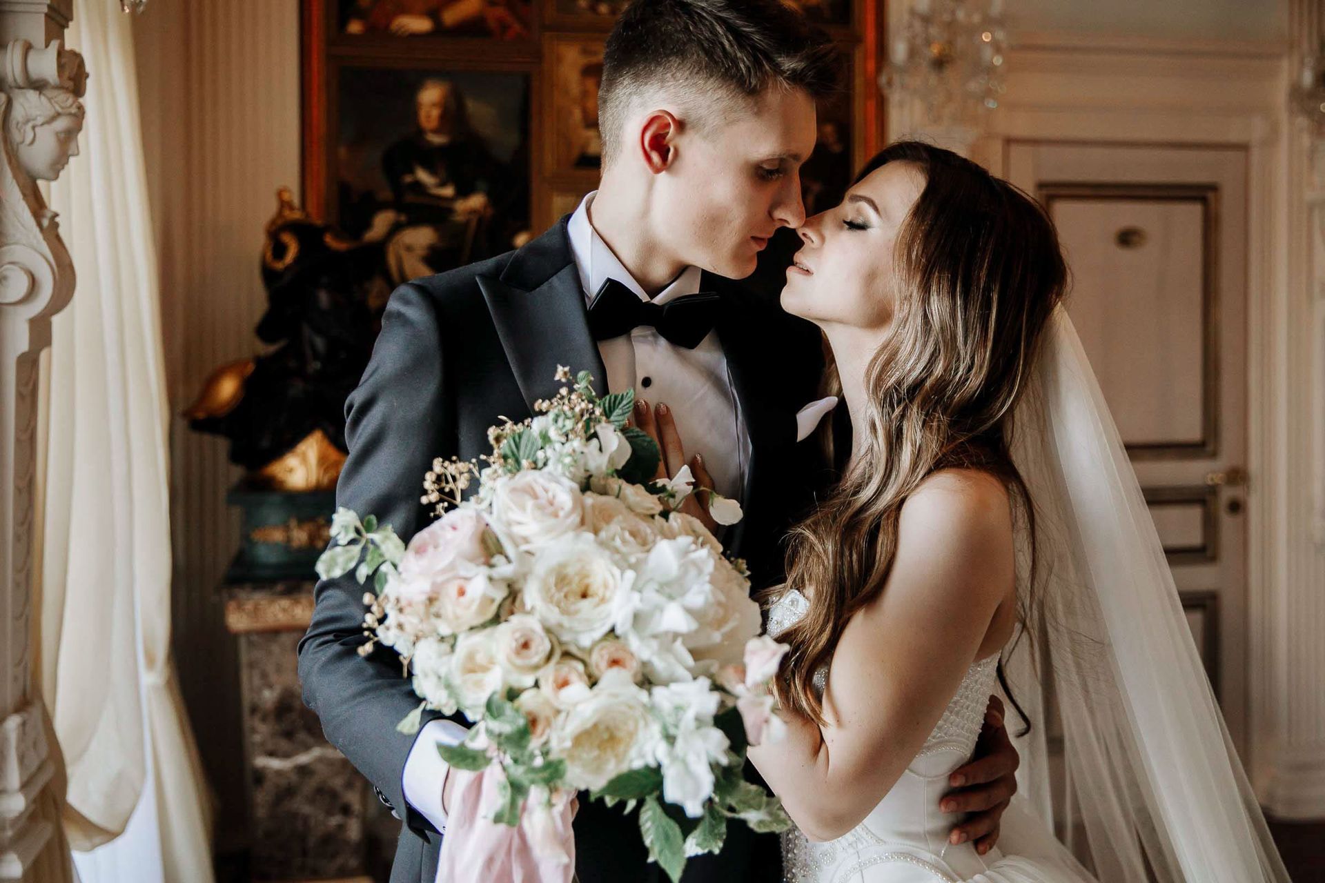 An editorial portrait of the couple in a grand hall by London photographer Tanya Bogdan.