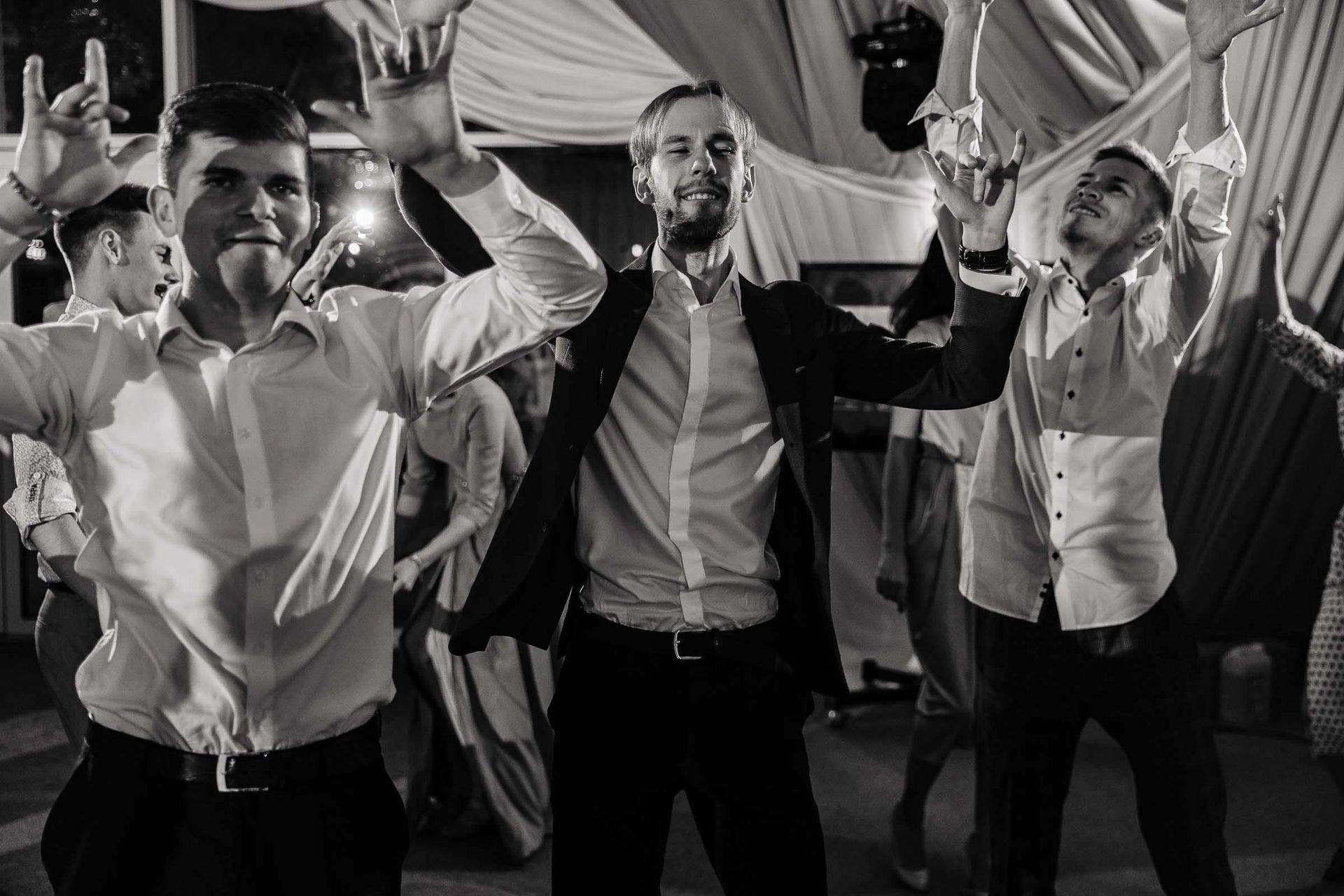High-energy photography of the groomsmen celebrating by Tanya Bogdan.
