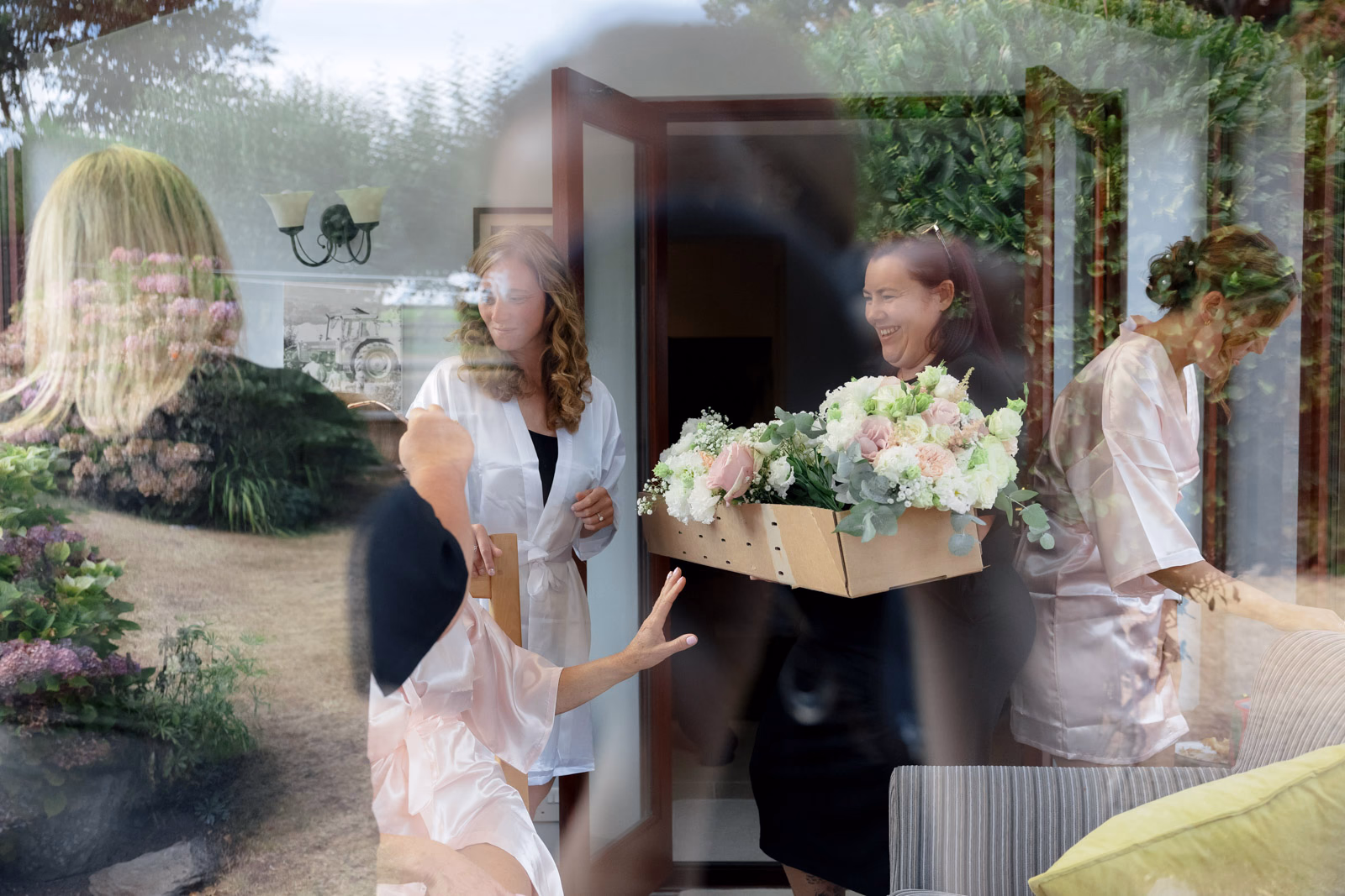 Bridesmaids carrying flowers bridal prep at a countryside wedding in Taunton, Somerset