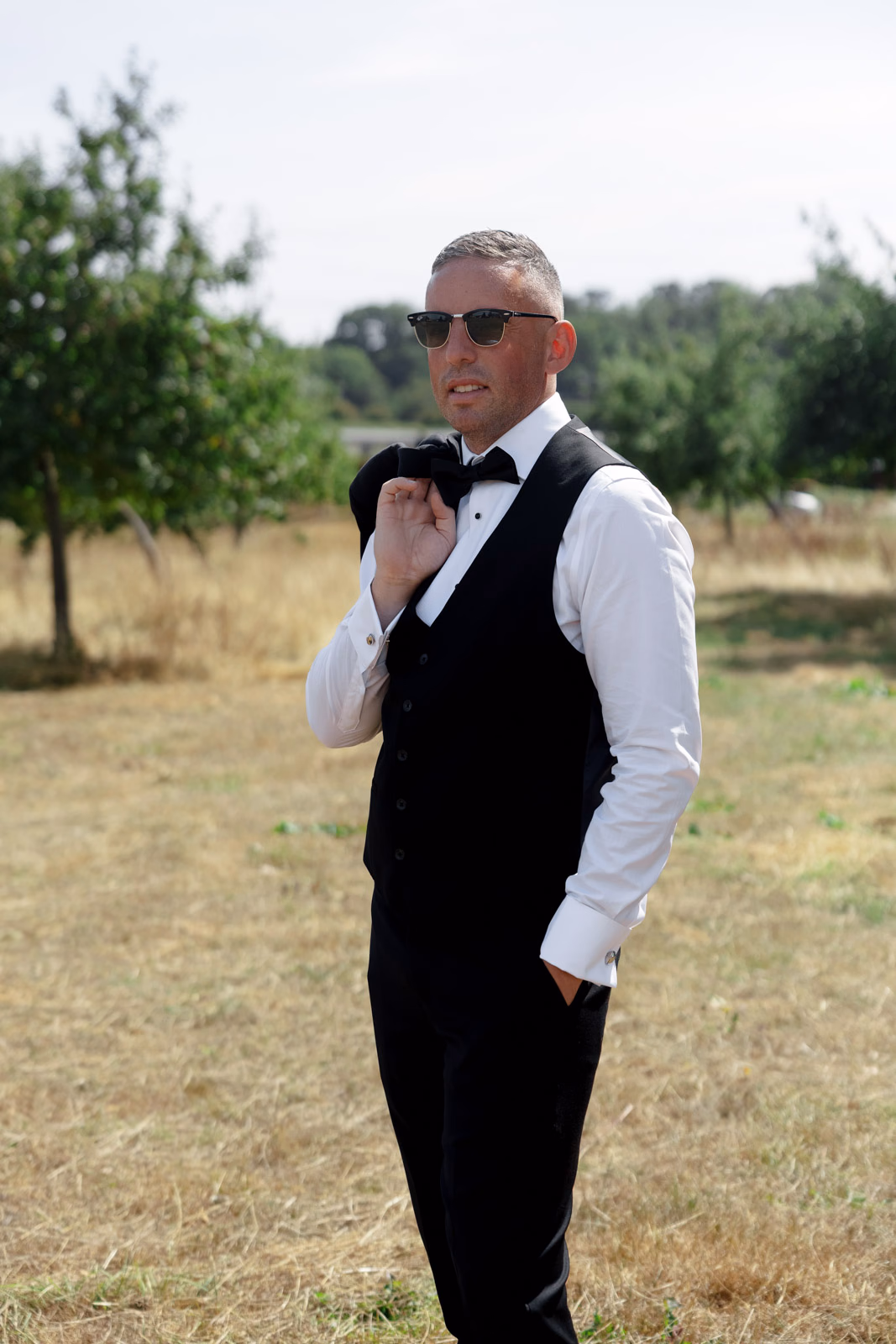 Groom portrait waistcoat countryside at a countryside wedding in Taunton, Somerset