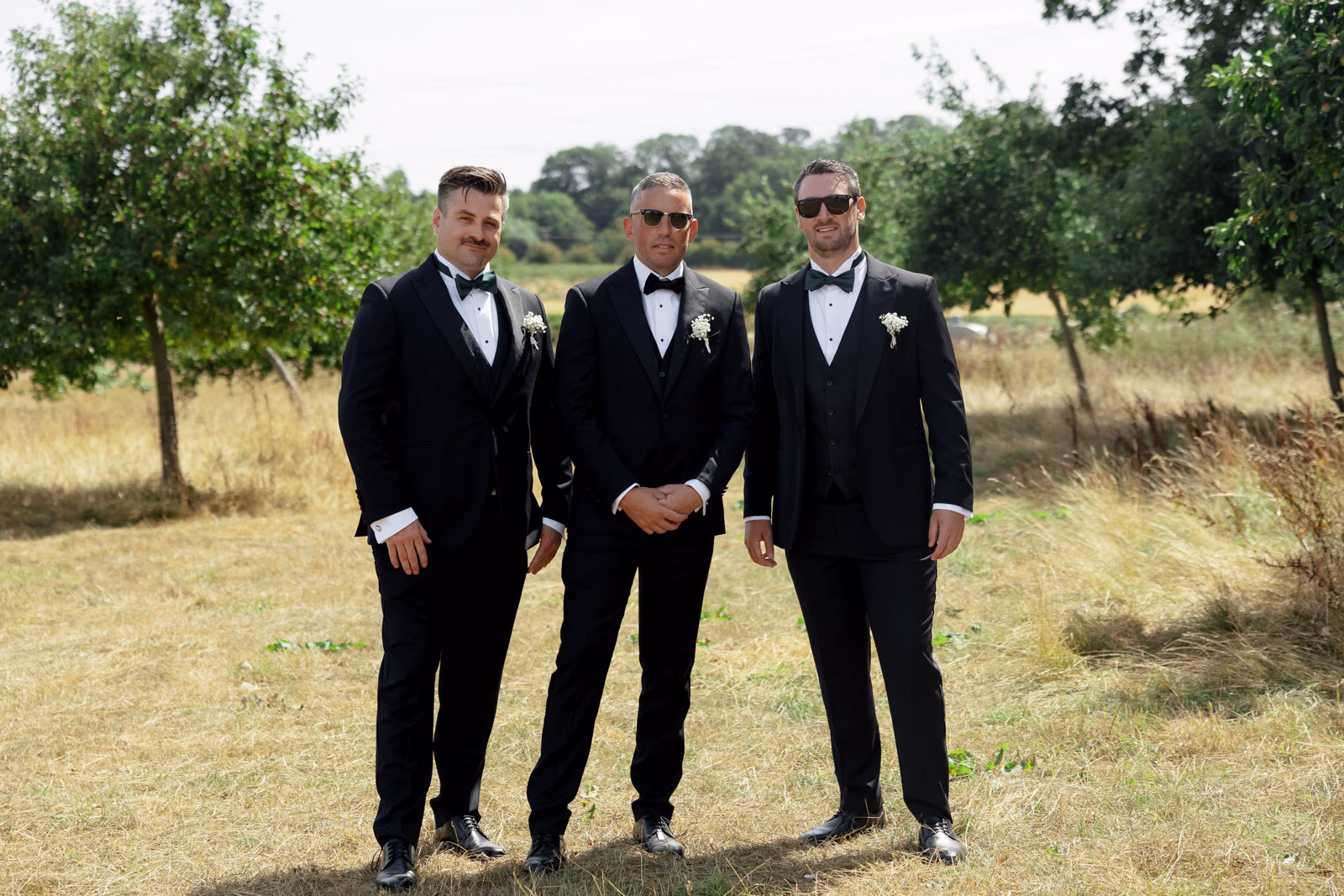 Groom and groomsmen full-length portrait at a family farm wedding in Taunton