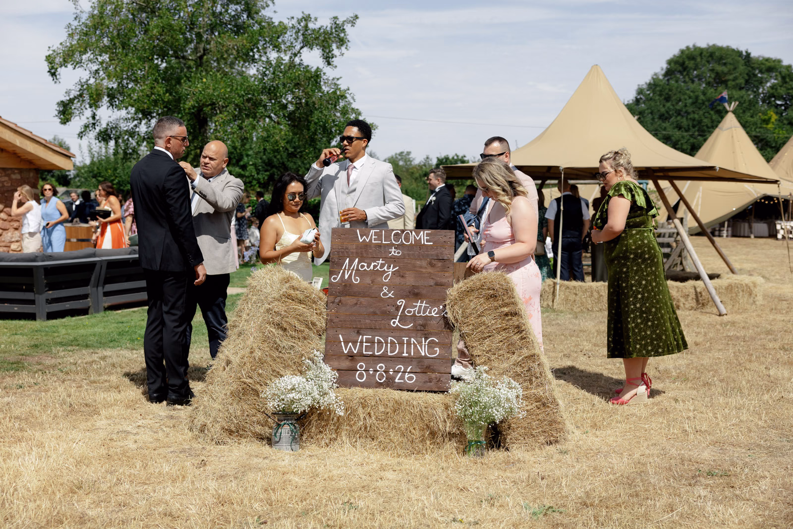 Guests arriving wedding welcome sign at a family farm wedding in Taunton