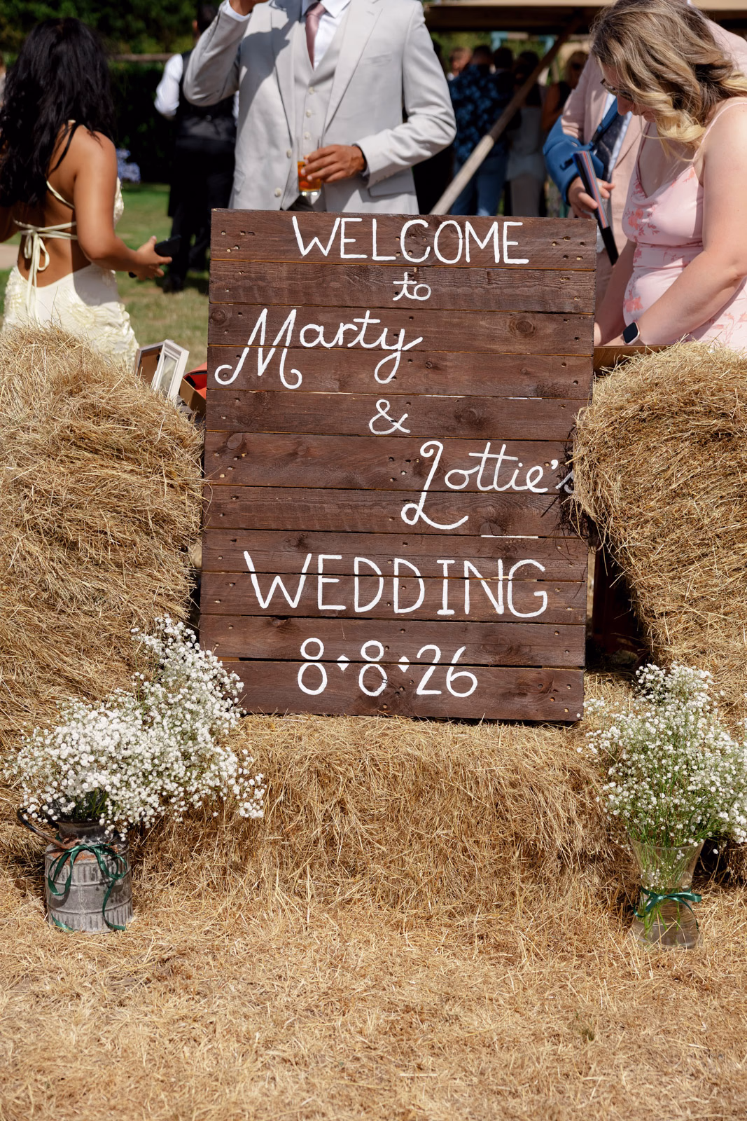 Rustic wedding welcome sign hay bales at a Taunton farm wedding, photographed by Tanya Bogdan Photography