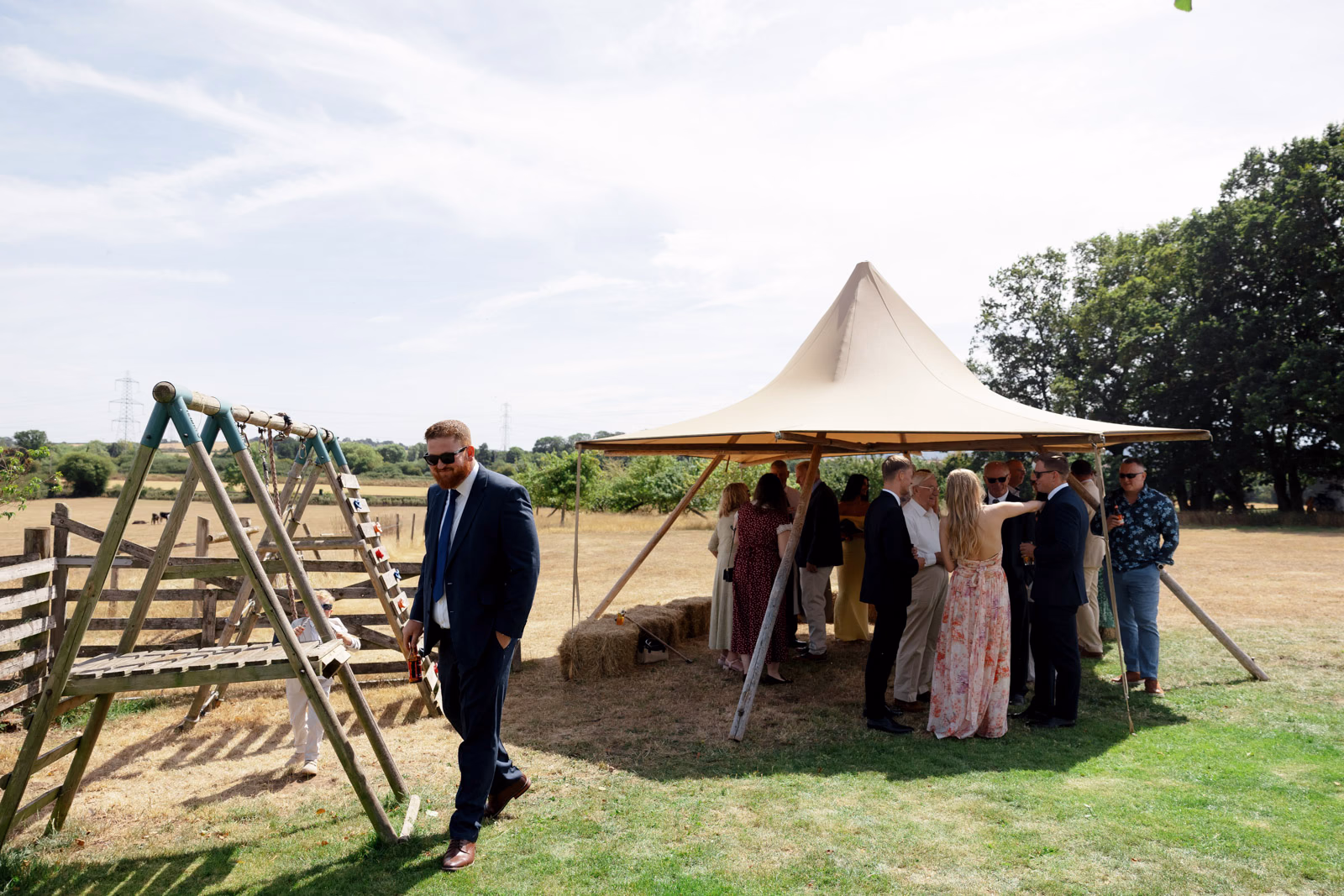 Guest arriving tipi welcome drinks at a family farm wedding in Taunton