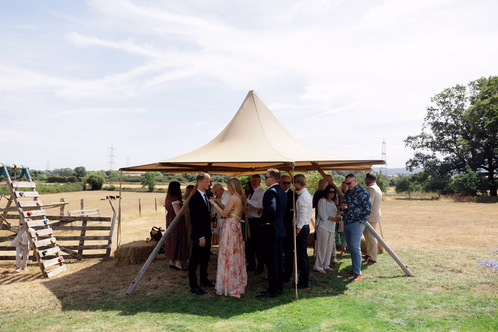 Guests mingling under tipi canopy at a countryside wedding in Taunton, Somerset
