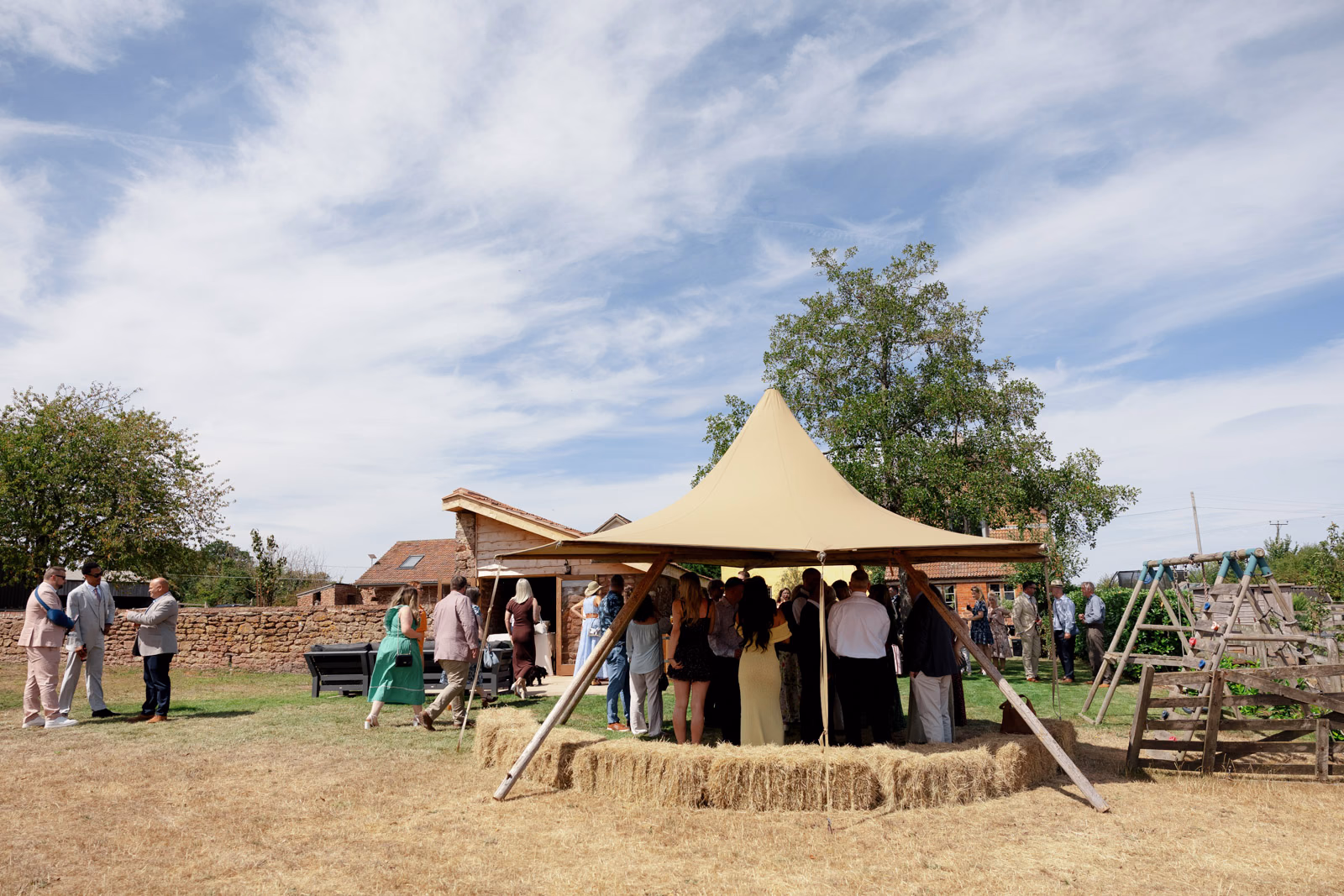 Guests gathering tipi wedding view at a countryside wedding in Taunton, Somerset