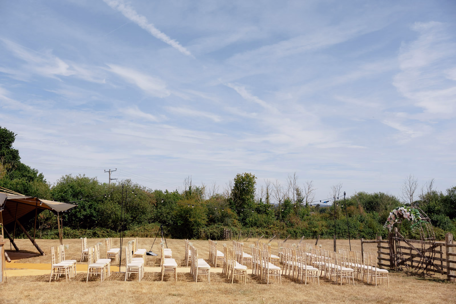 Outdoor ceremony chairs set up in field at a Taunton farm wedding, photographed by Tanya Bogdan Photography