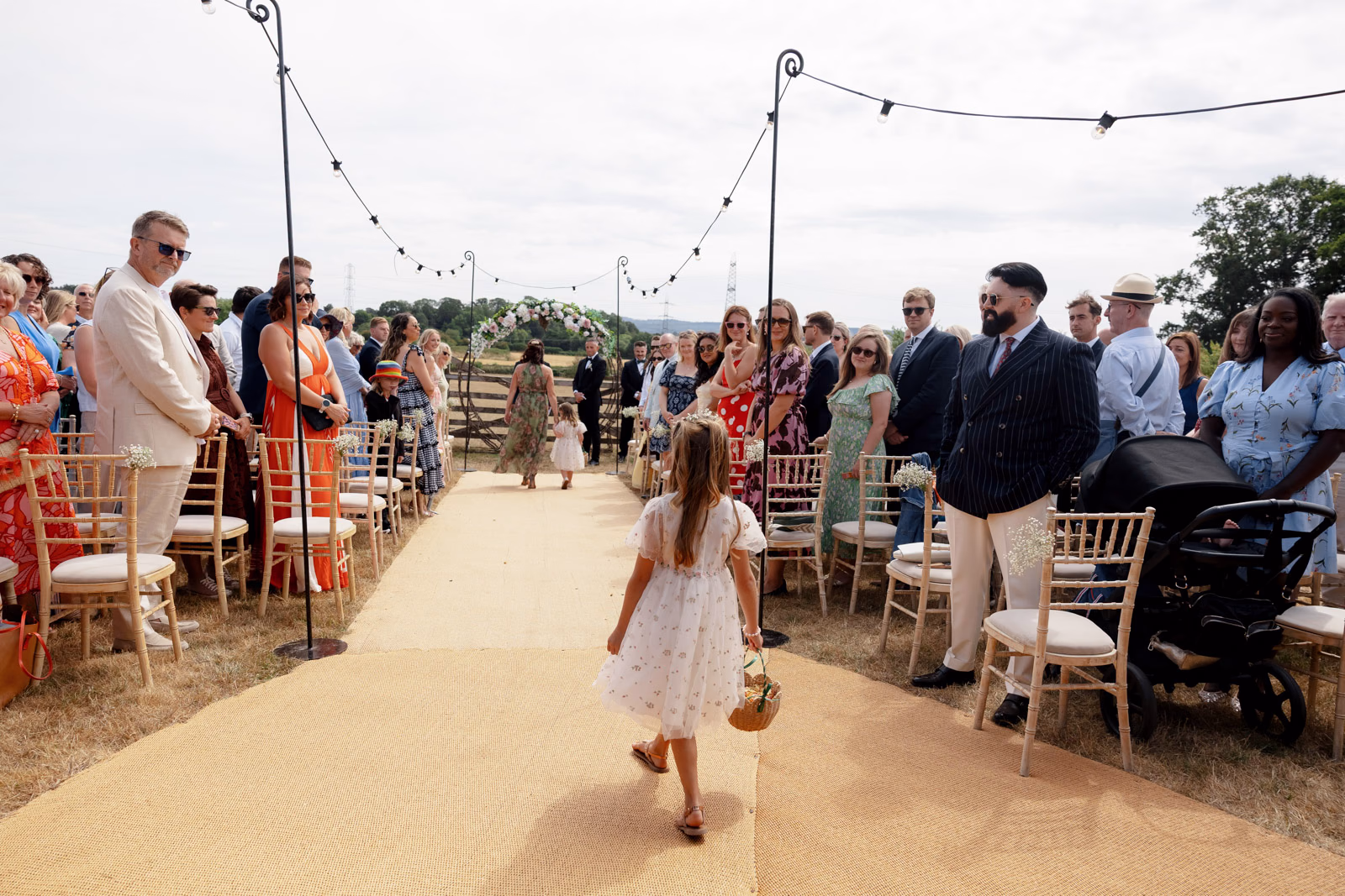 Flower girl aisle guests watching at a countryside wedding in Taunton, Somerset