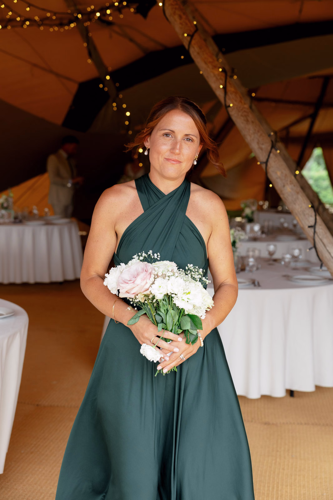 Bridesmaid portrait dark green dress bouquet at a family farm wedding in Taunton