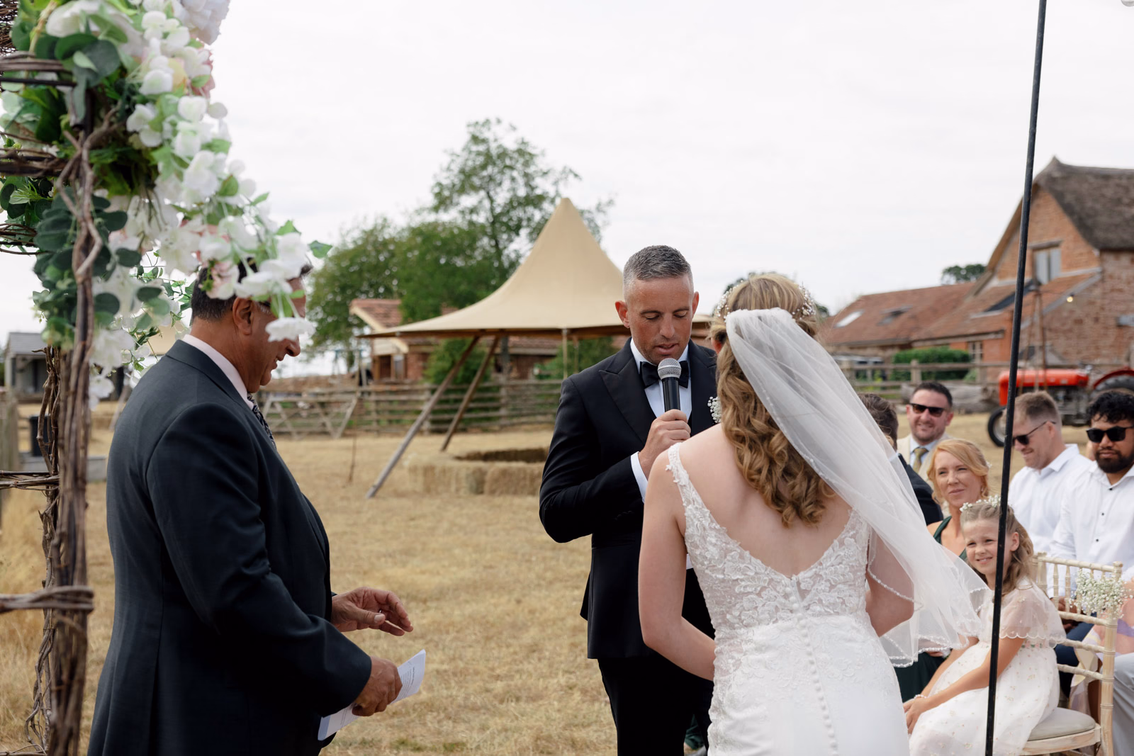 Bride and celebrant during ceremony at a countryside wedding in Taunton, Somerset