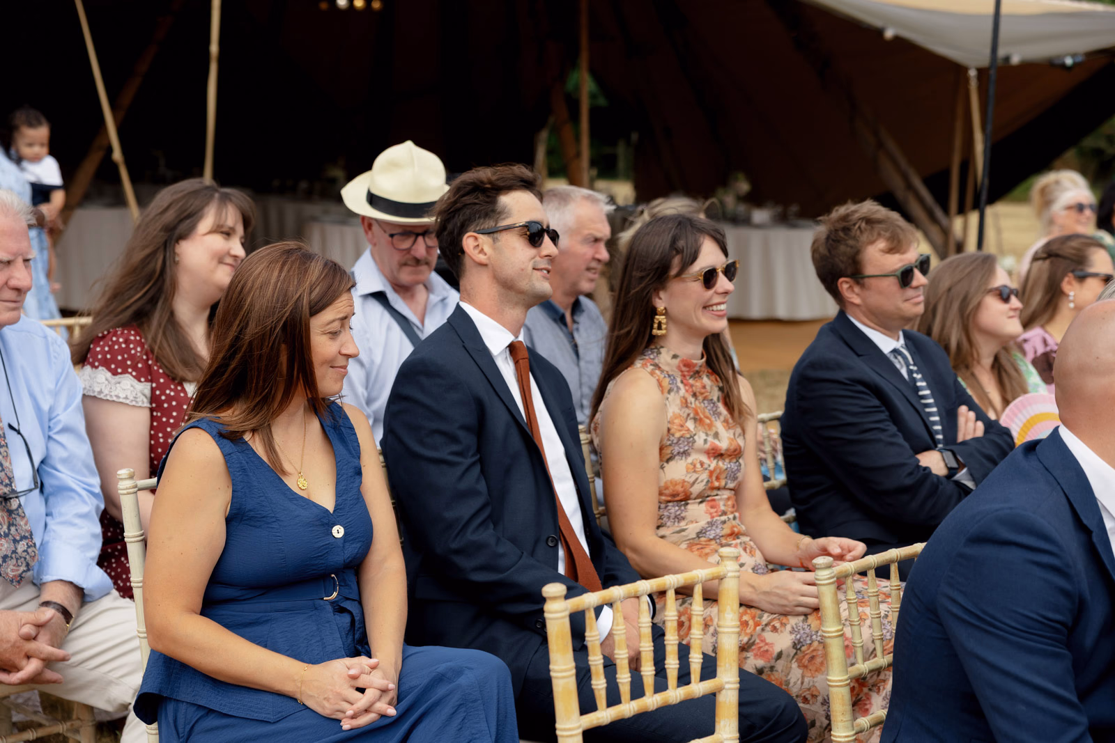 Guests smiling watching ceremony at a countryside wedding in Taunton, Somerset