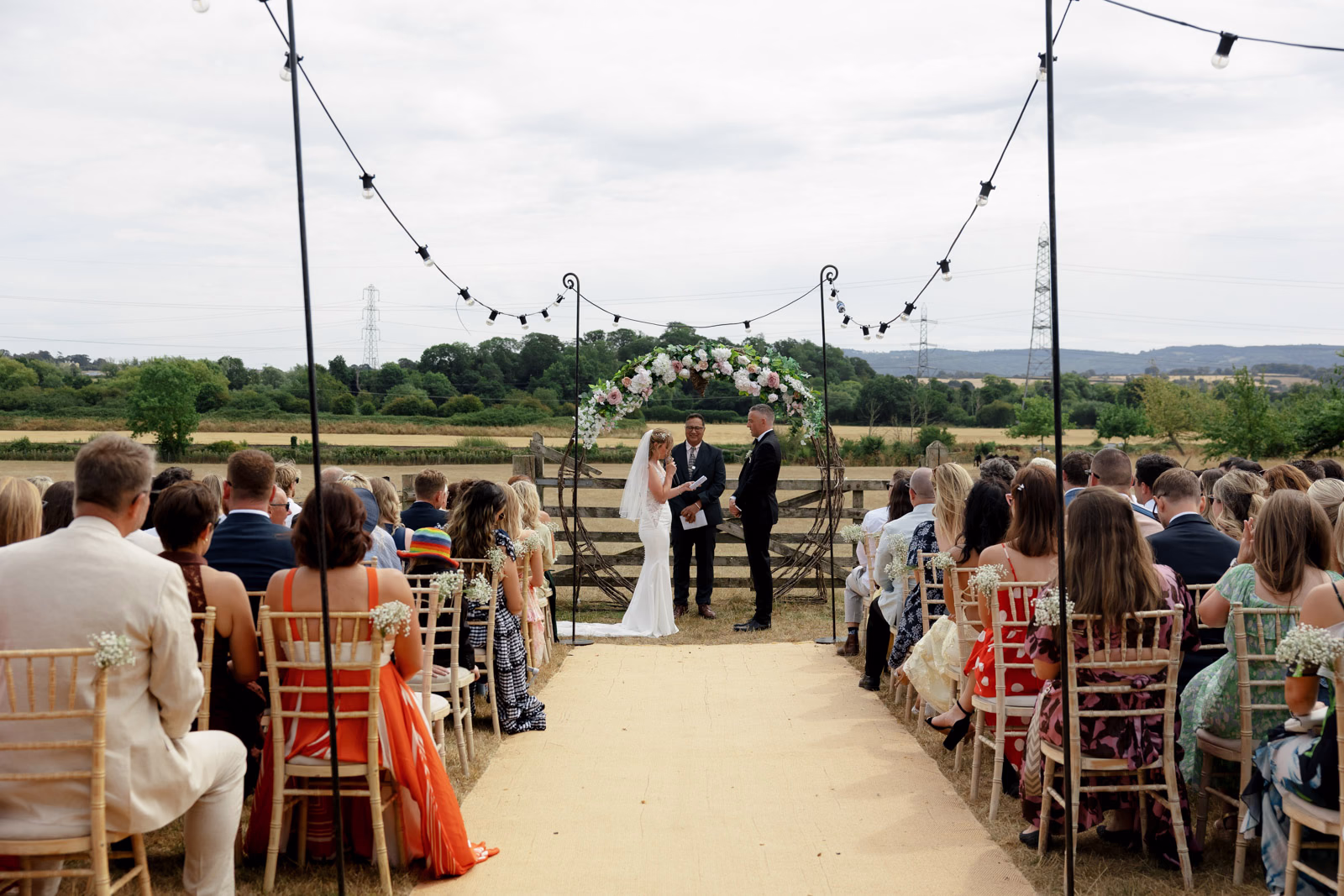 Ceremony aisle wide view guests at a family farm wedding in Taunton
